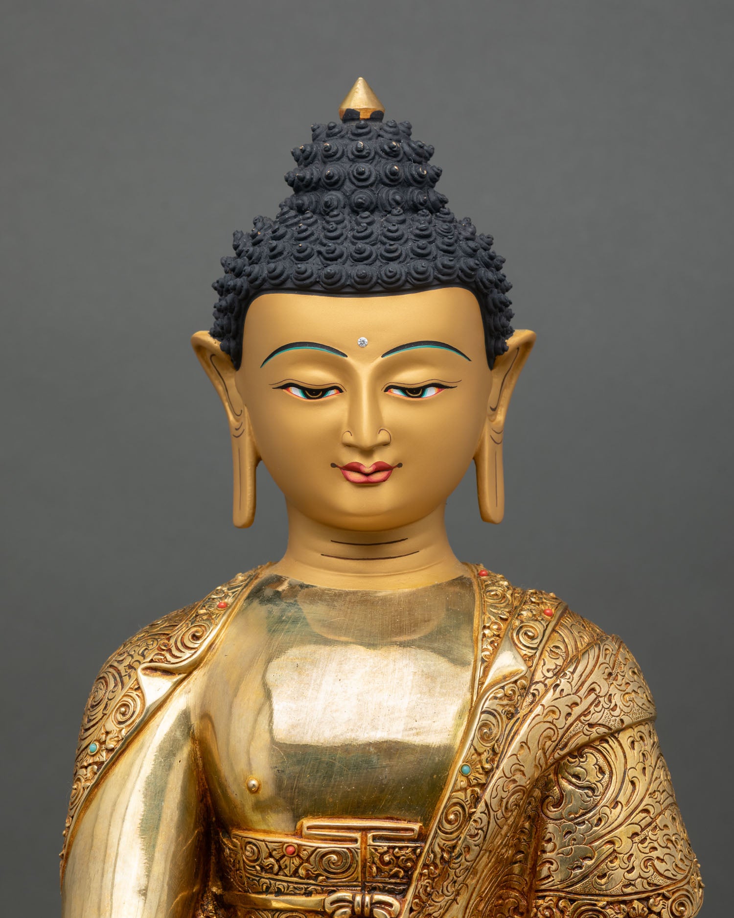 Close up Amitabha Buddha face gold painted serene expression Himalayan Buddhist art