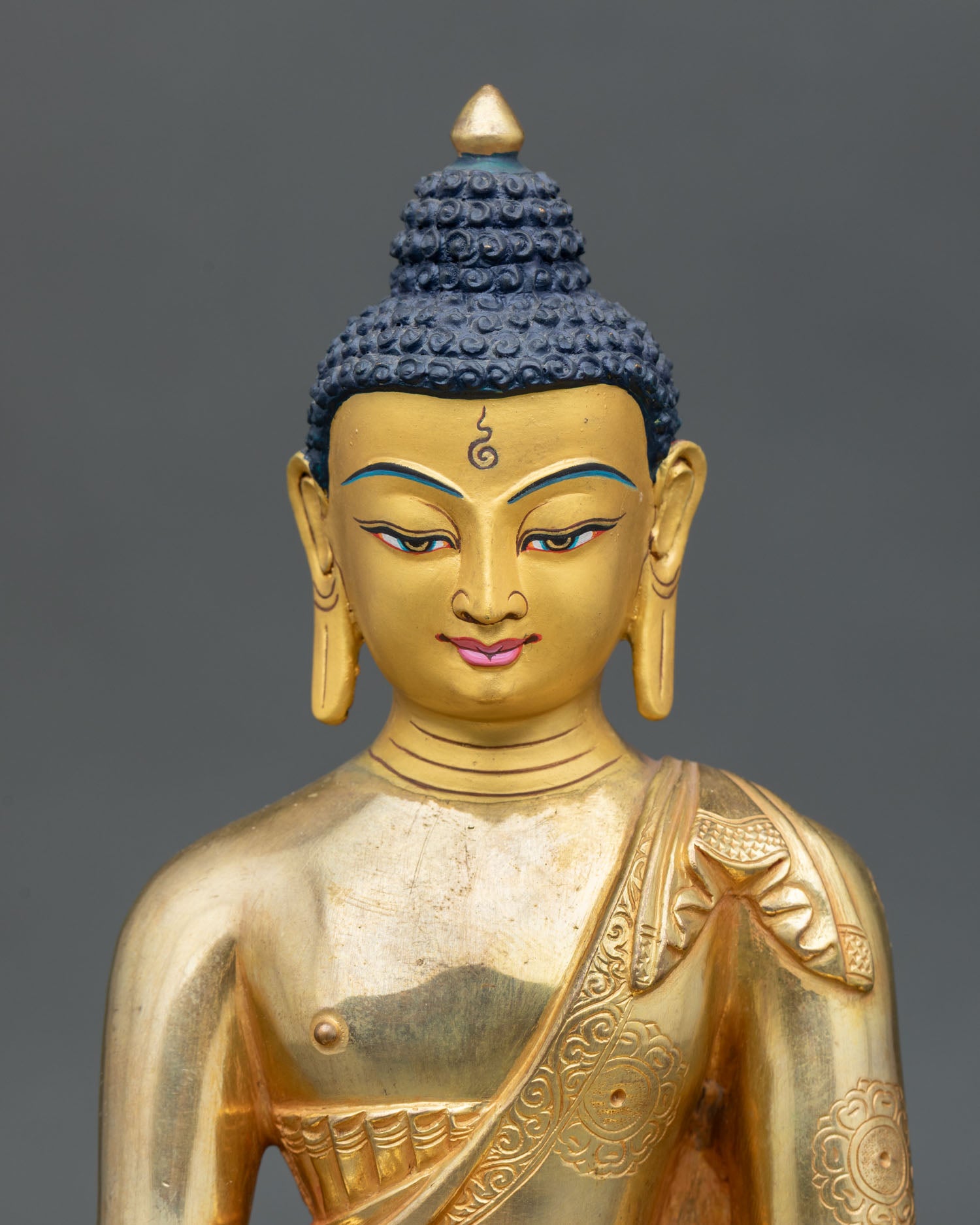 Close up Amitabha Buddha sculpture detail gold painted face copper craftsmanship Newari artisan Nepal floral robe engraving Buddha of infinite light