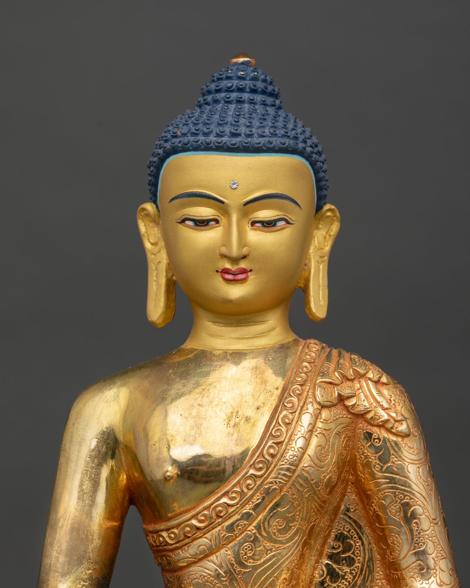 Close up Amitabha Buddha serene gold painted face detail lost wax casting Himalayan Buddhist art meditation and devotion statue
