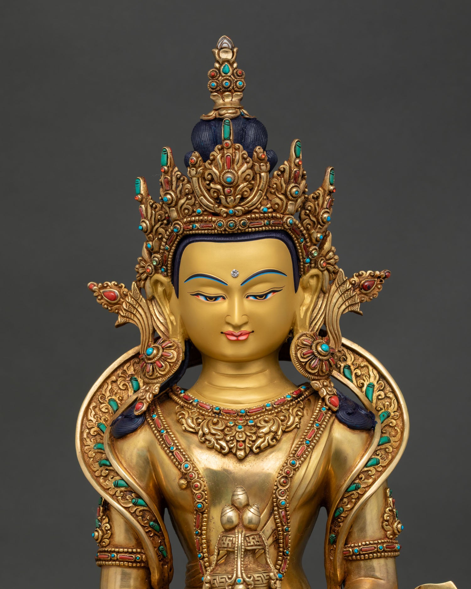 Close up Amitayus statue, gold-gilded face, detail semi precious stones, Nepal