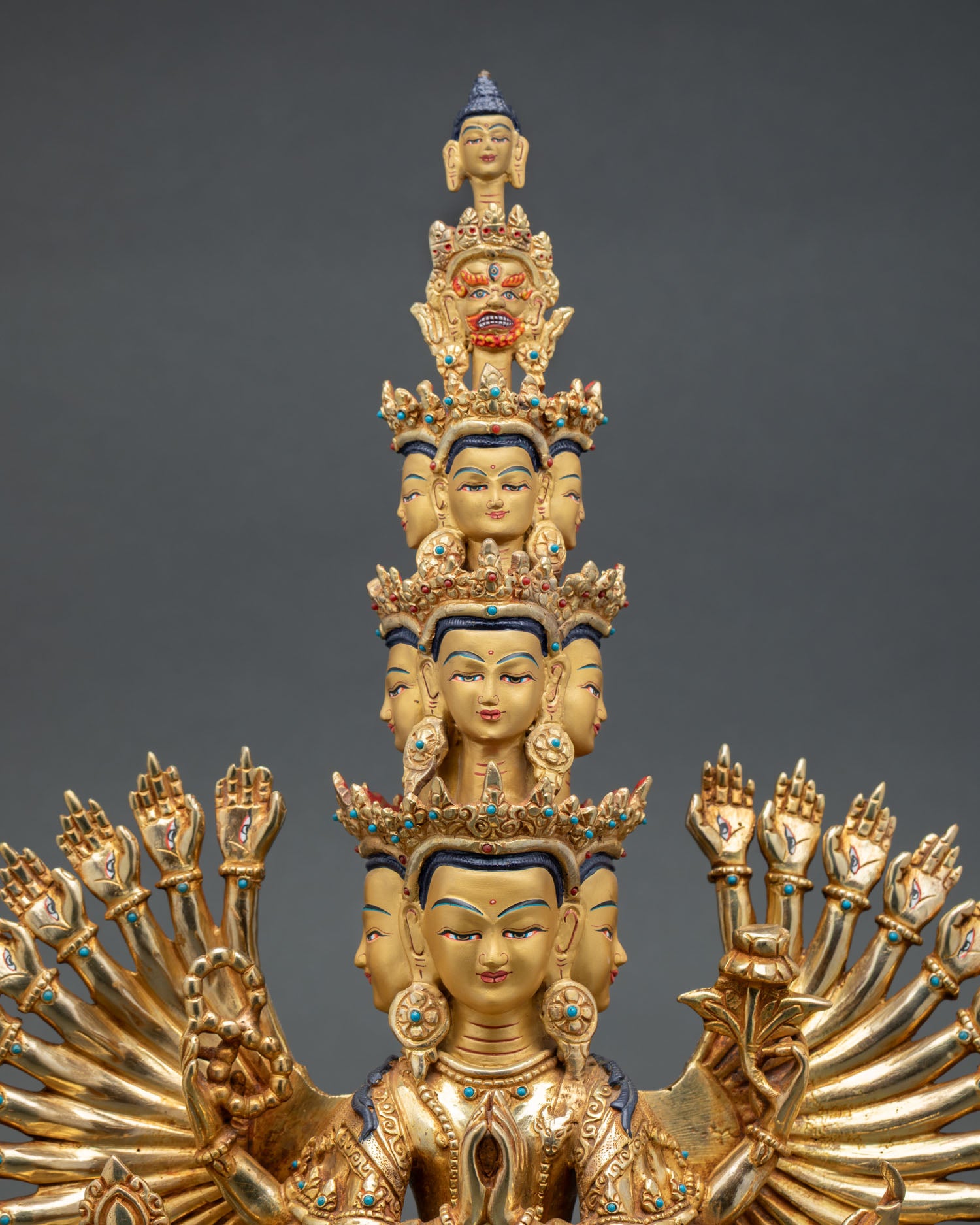 Close up Avalokiteshvara face with eleven tiers of wisdom eyes and serene expression Himalayan Buddhist detailing