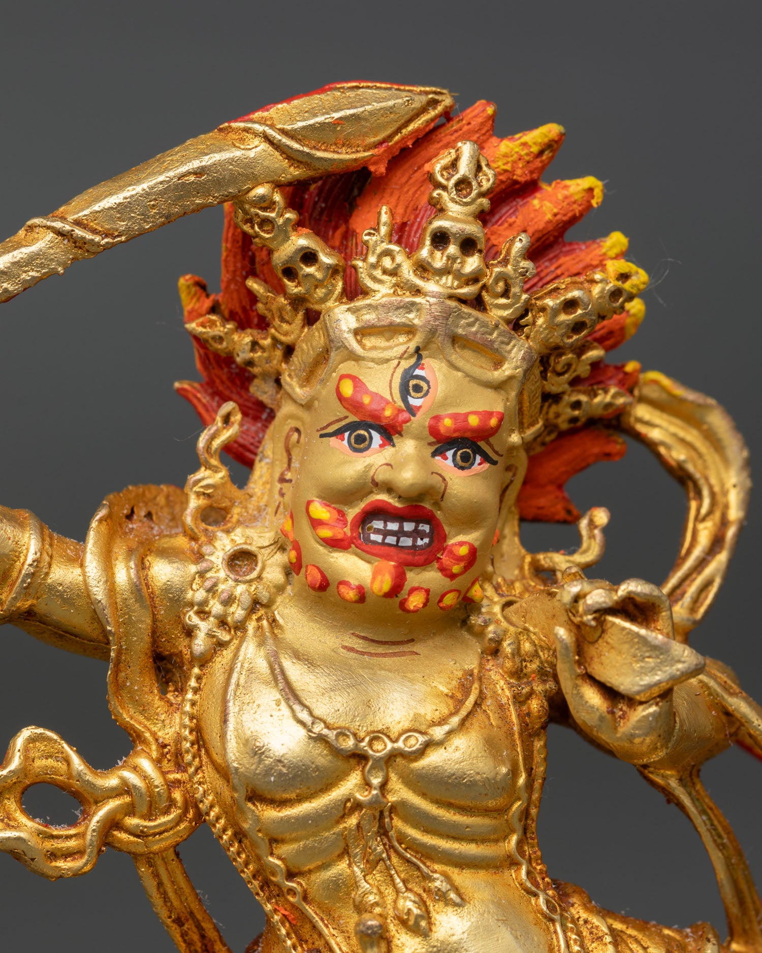 Close up Black Manjushri statue gold painted face third eye five skull crown fiery halo detailed Himalayan lost wax casting sculpture