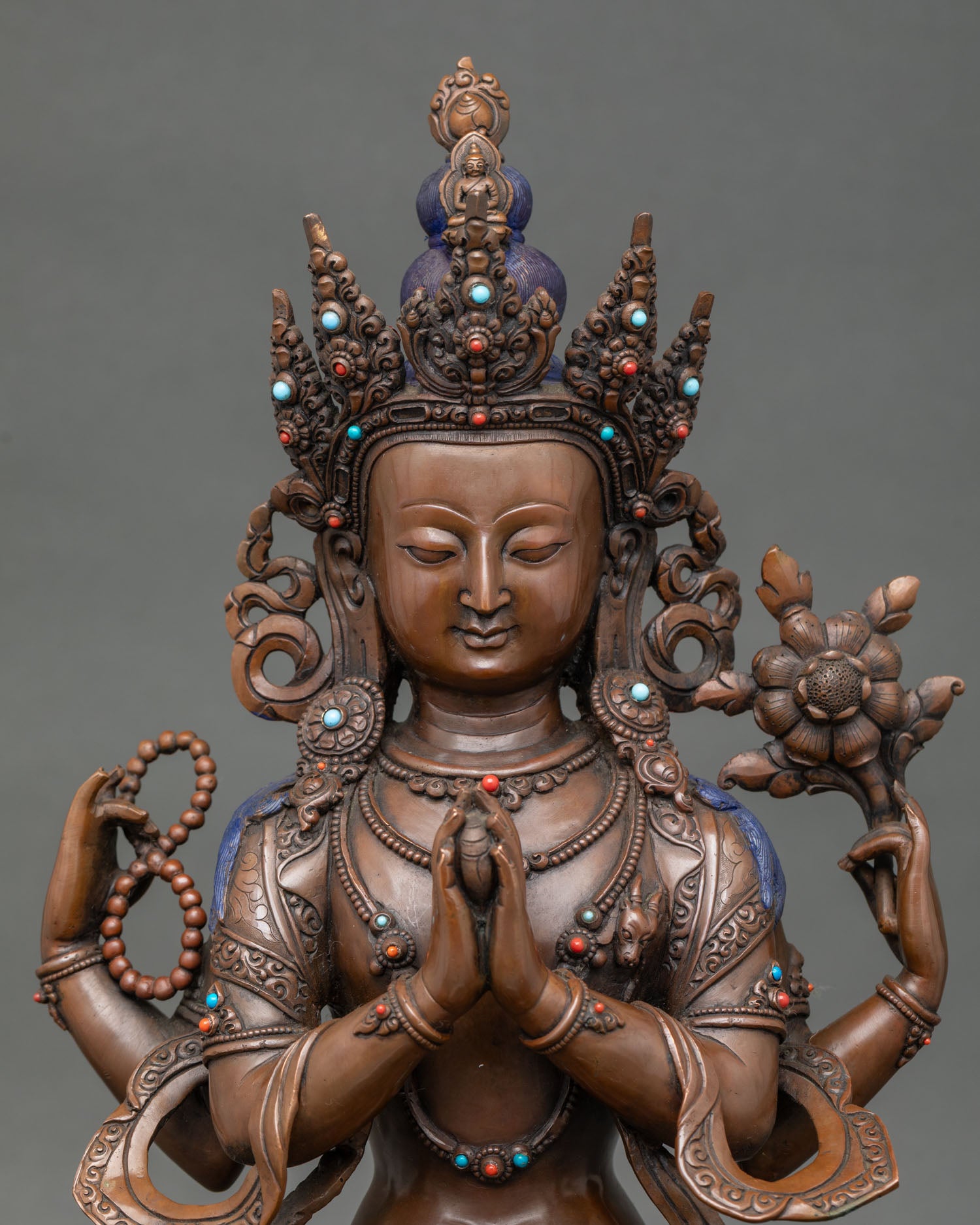 Close up of Chenrezig face with oxidized finish and stone inlay compassion deity