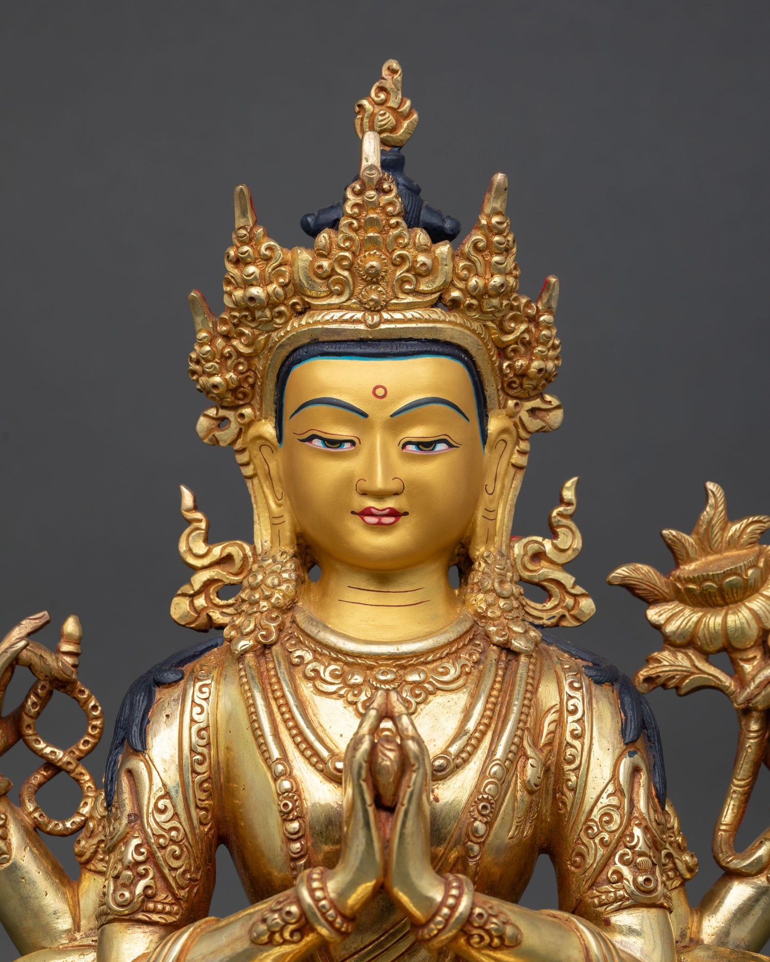Close up Chenrezig serene face detail gold painted expression copper statue with 24K gold finishing Nepalese craftsmanship