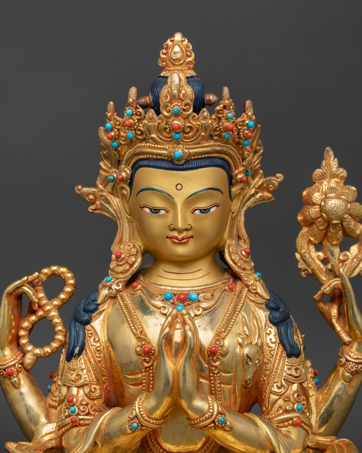 Close-up Chenrezig statue details showing intricate craftsmanship, traditional Himalayan Buddhist art sculpture
