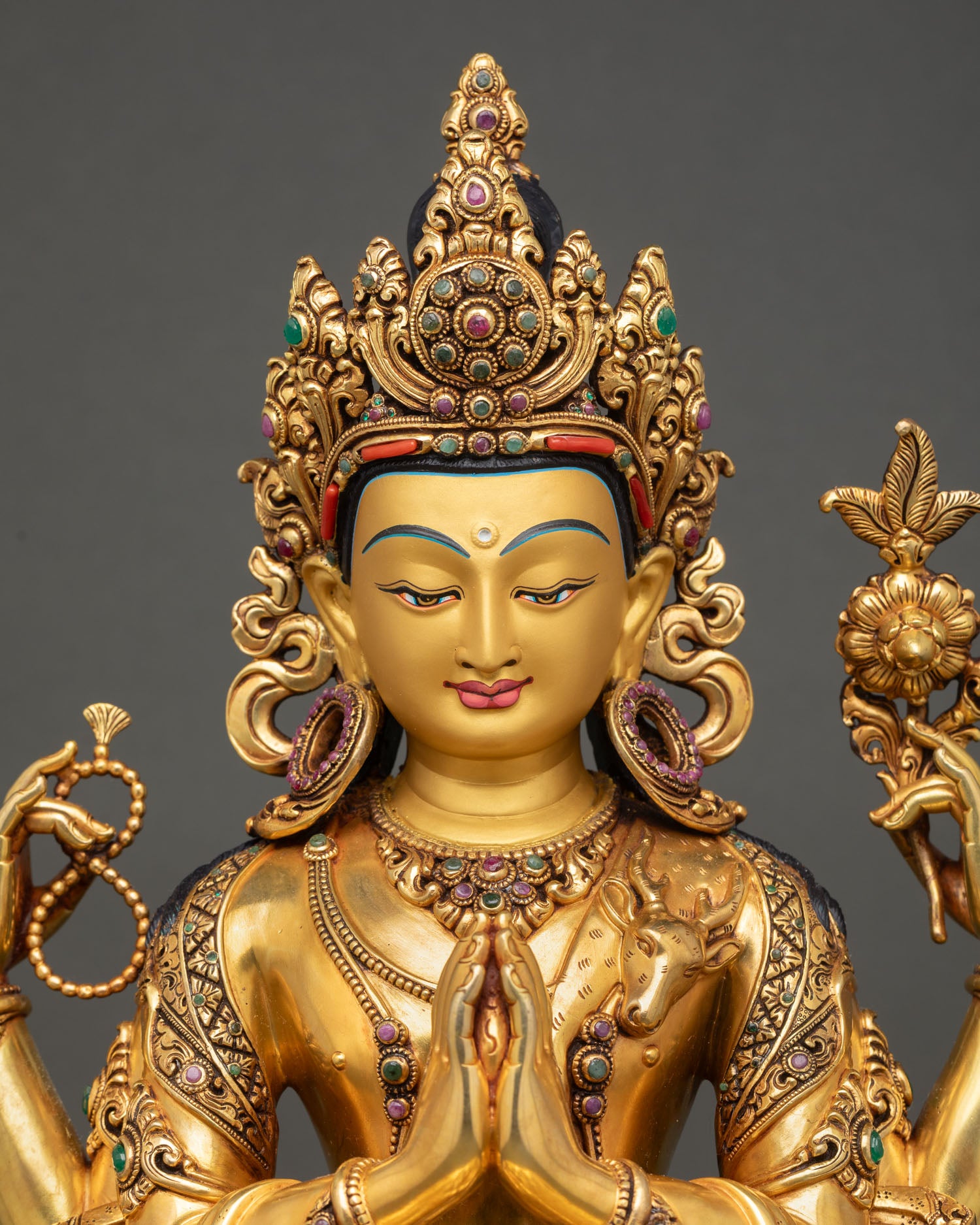 close up chenrezig statue intricate gold gilding repoussΓ© details nepal buddhist craftsmanship