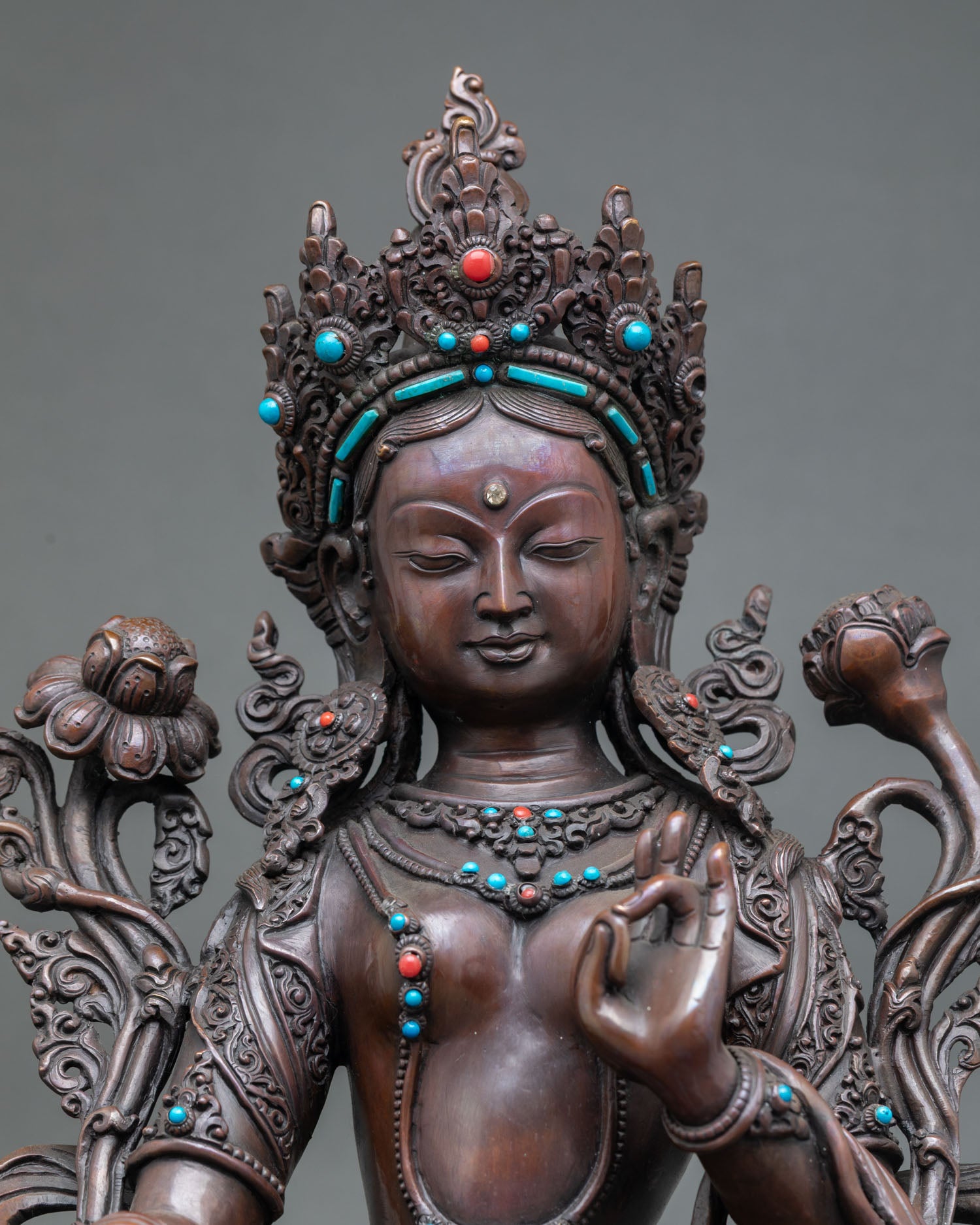 Close up detail of White Tara Saptalocana face and hands showing seven eyes on forehead and palms with intricate Newari craftsmanship