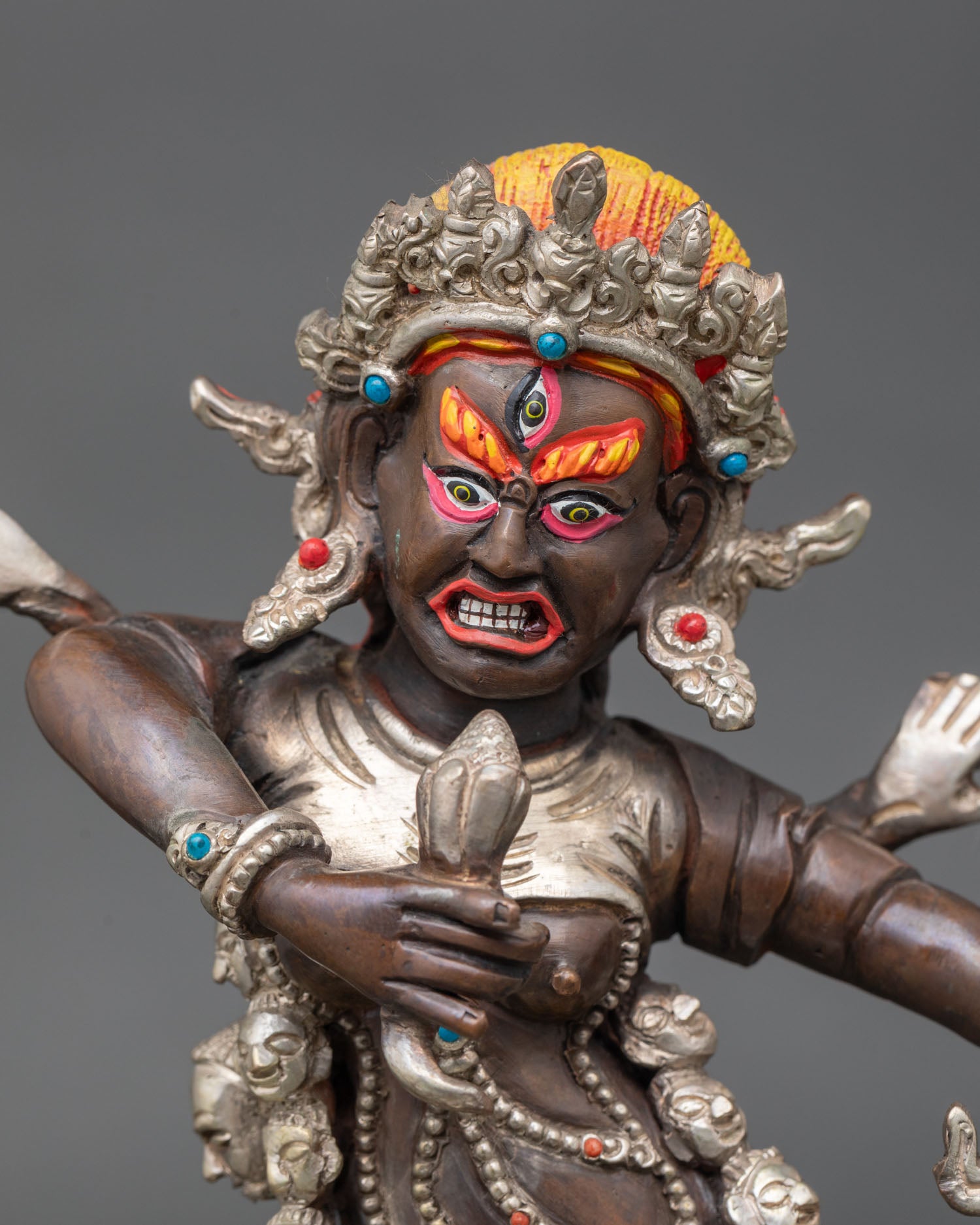 Close up Drogdze Wangmo face detail wrathful female protector deity Himalayan Buddhist art Newari craftsmanship sacred guardian expression