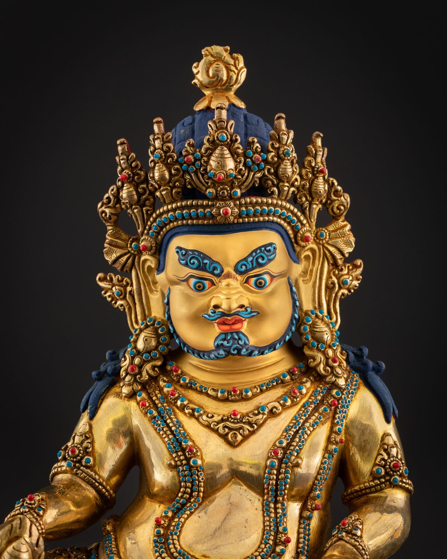 Close-up of Dzambhala statue, turquoise coral inlay halo, intricate Newari details