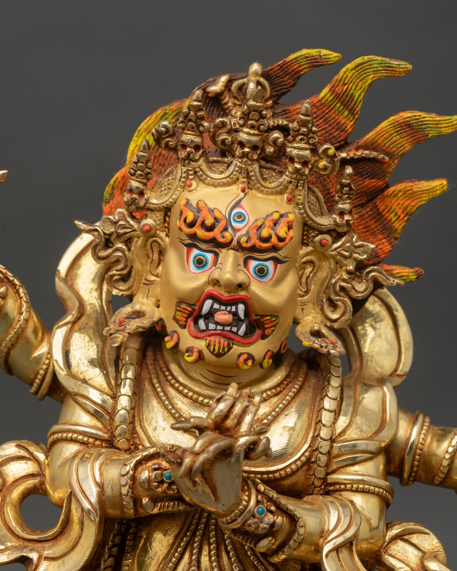 Close up Four-Armed Vajrapani face with third eye gold details wrathful expression Himalayan Buddhist guardian sculpture