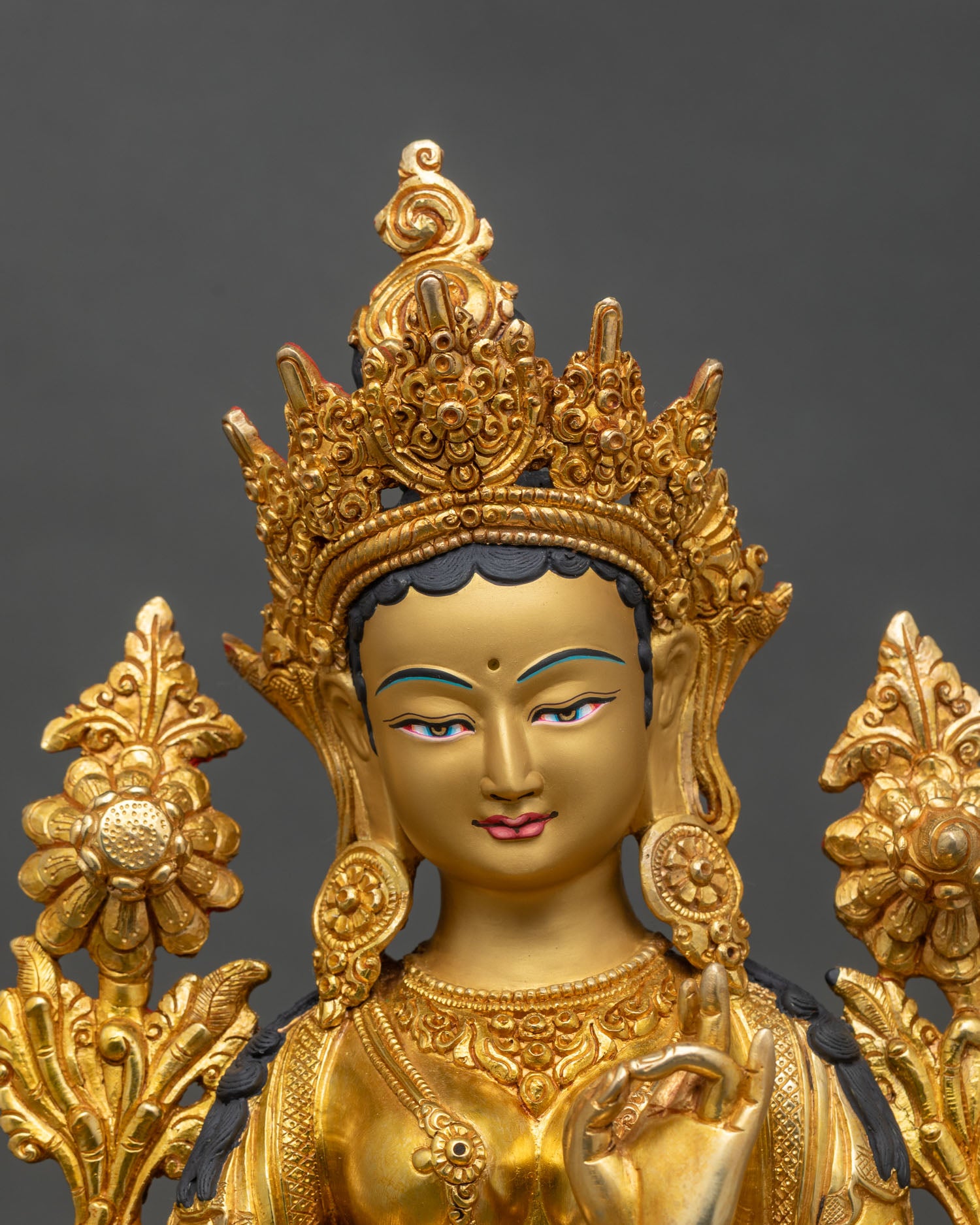 Close up Green Tara face hand painted details Newari artisan compassionate deity sculpture