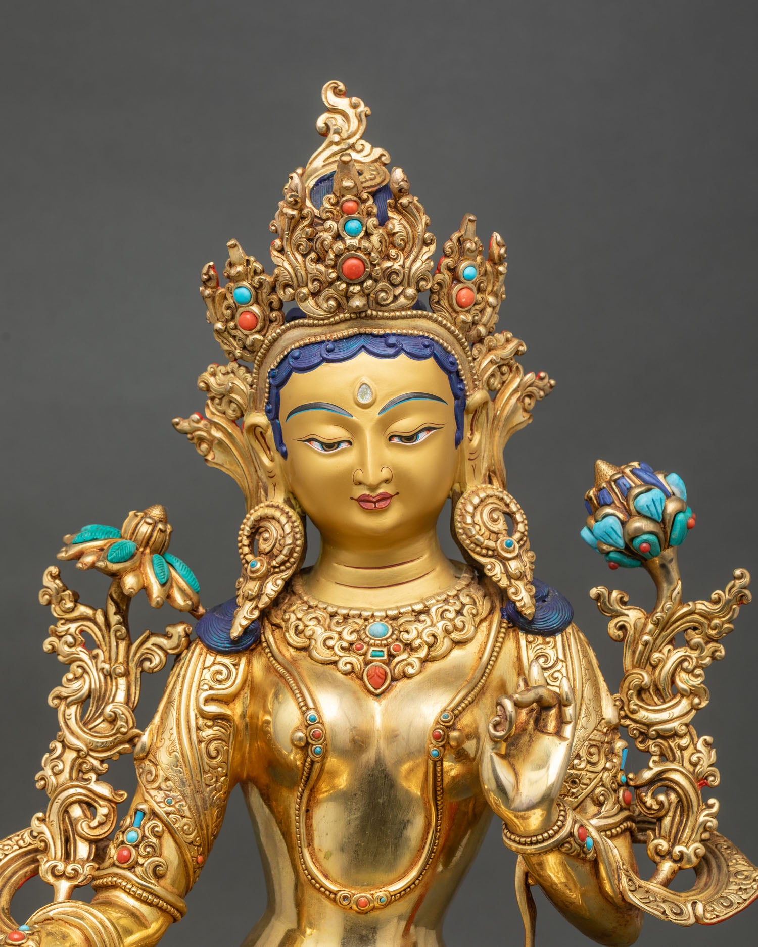 Close up Green Tara Buddha face, Serene expression with semi-precious stones