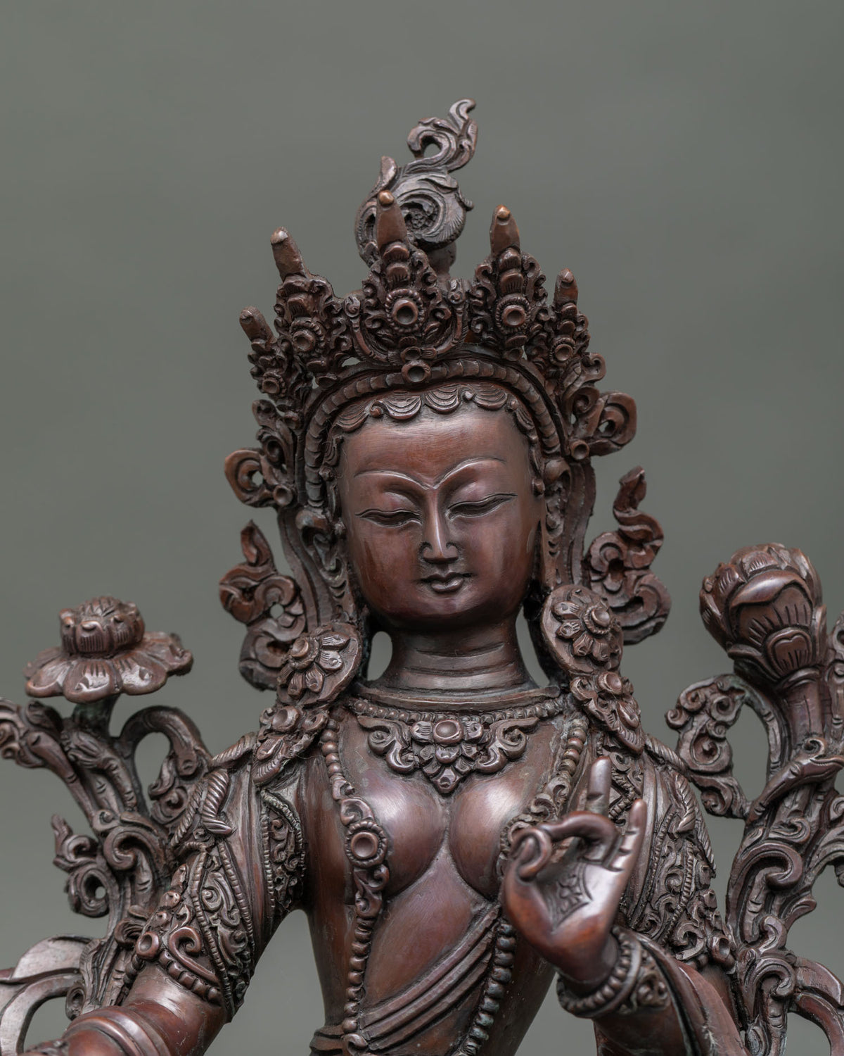 Close-up Green Tara statue showing intricate oxidized copper details and traditional Nepalese craftsmanship