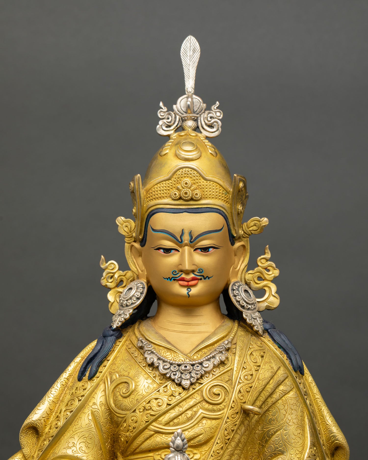 Close up Guru Rinpoche gold painted face silver plated details Himalayan Newari craftsmanship Patan Nepal