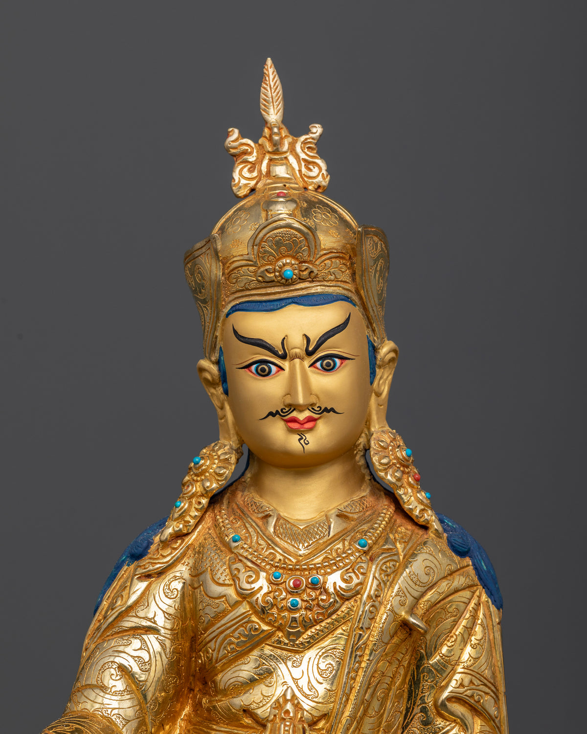 Close Up Guru Rinpoche Statue with Gold-Painted Face and Semi-Wrathful Expression