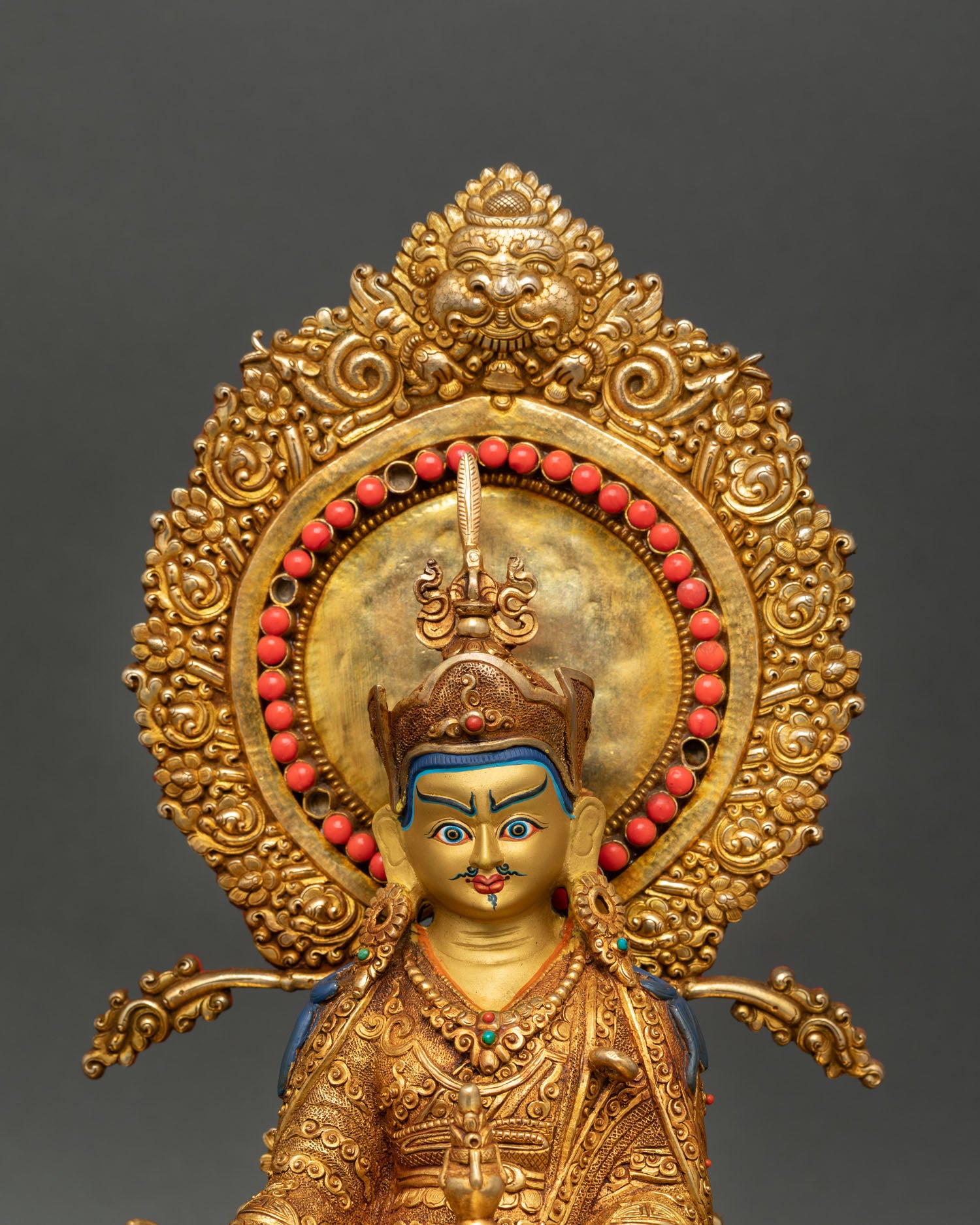 Close up view of Guru Rinpoche statue highlighting the skull cup, vajra, khatvanga, and sacred tantric symbolic details.