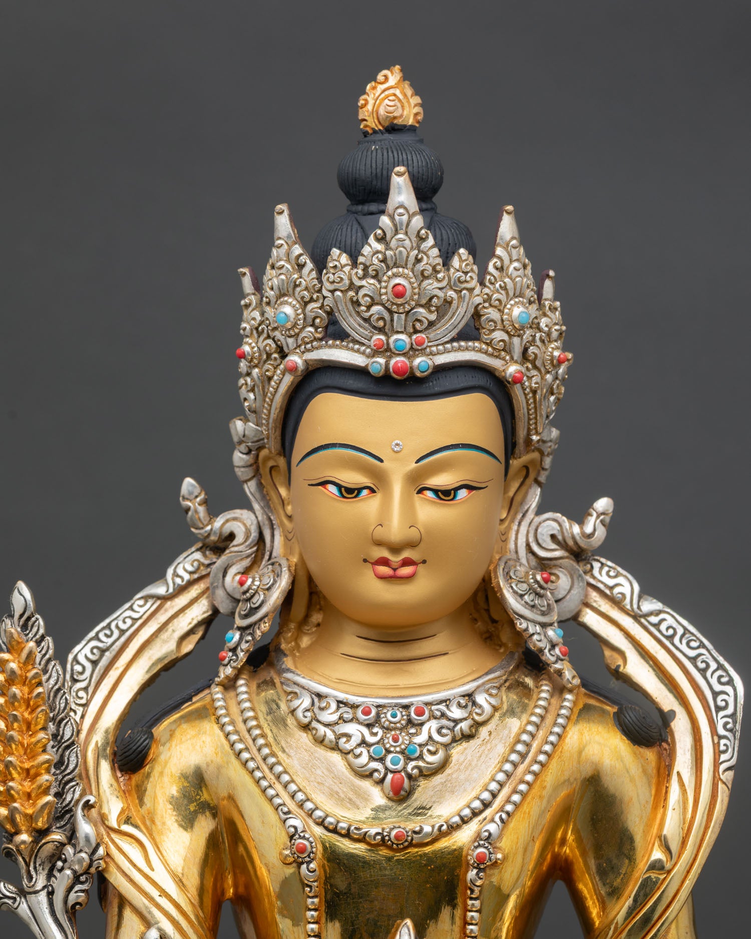 Close up Kshitigarbha statue face detail gold painted serene expression traditional Nepalese craftsmanship Patan artisan Buddhist deity sculpture