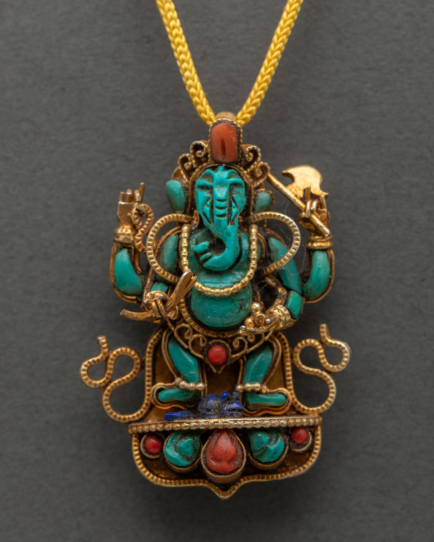 Close up Lord Ganesha locket with gold plated copper and gemstones