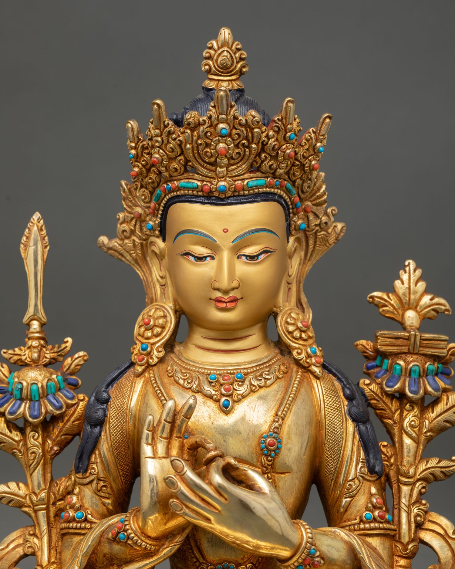 Close up of Manjushree face gold painted serene expression handcrafted Nepal