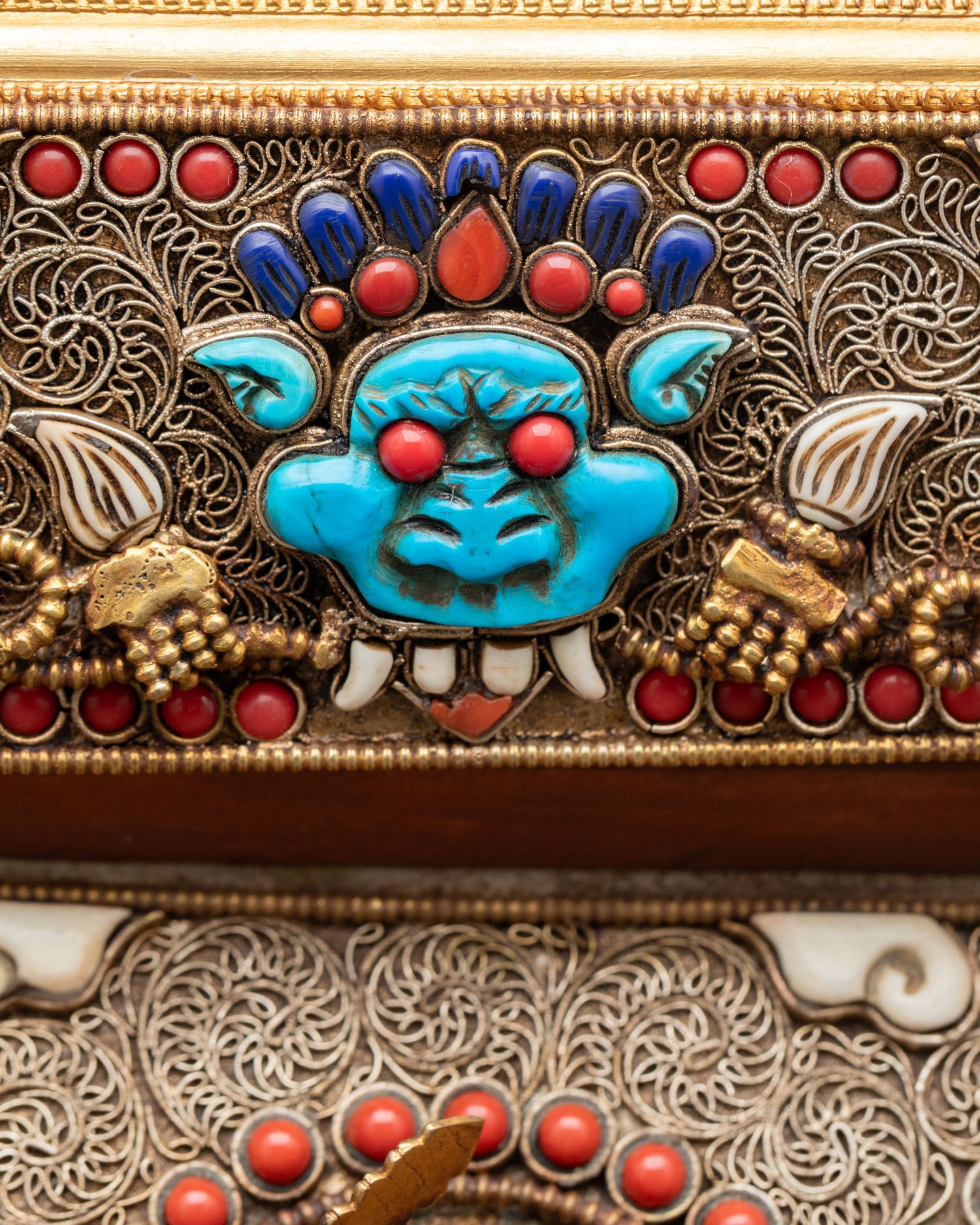 Close up Manjushree wall hanging detail Garuda Vajra symbols semi precious stones Himalayan spiritual art