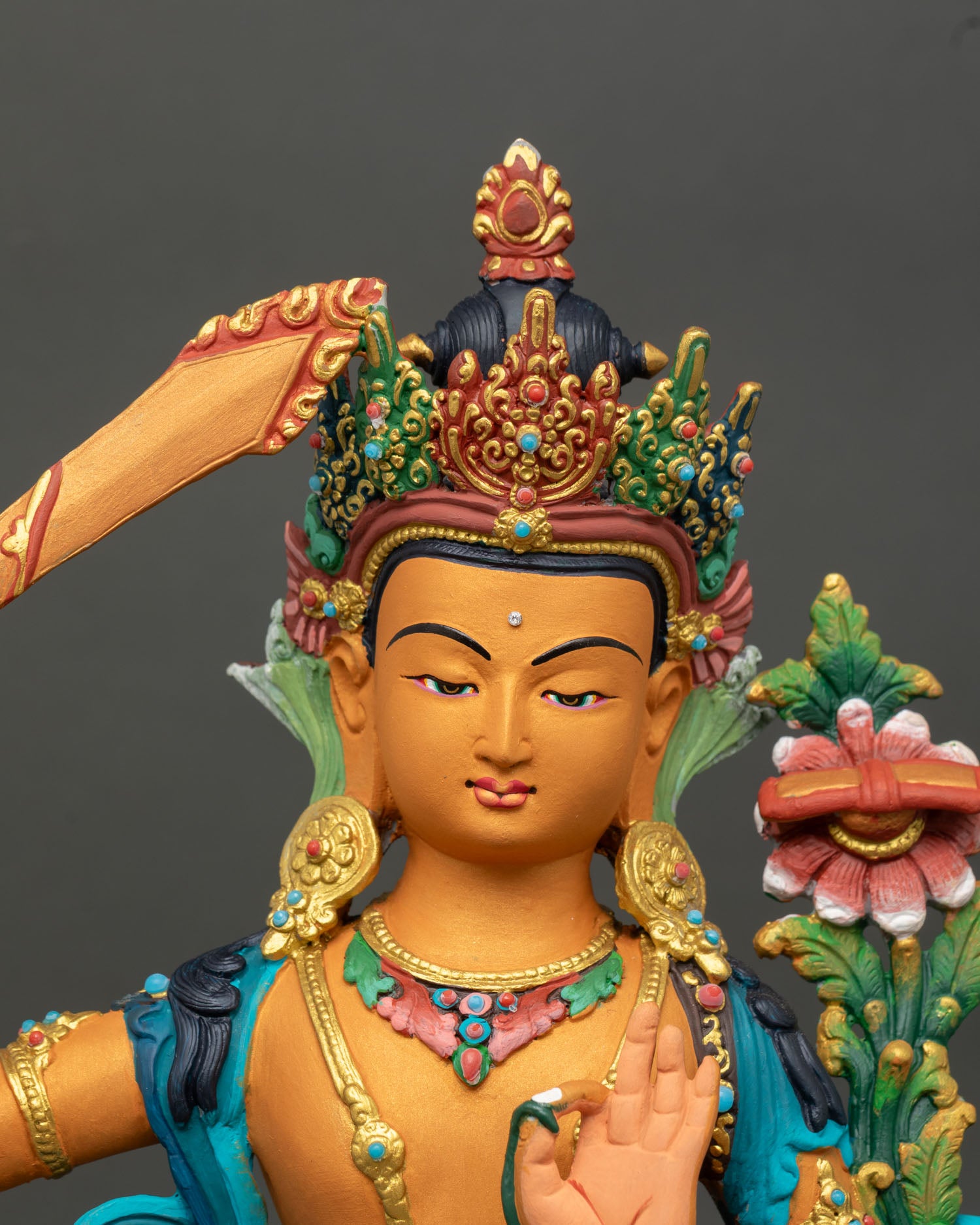 Close-up Manjushri face gold-gilded jewelry detailed craftsmanship semi-precious stone Buddhist sculpture Nepal