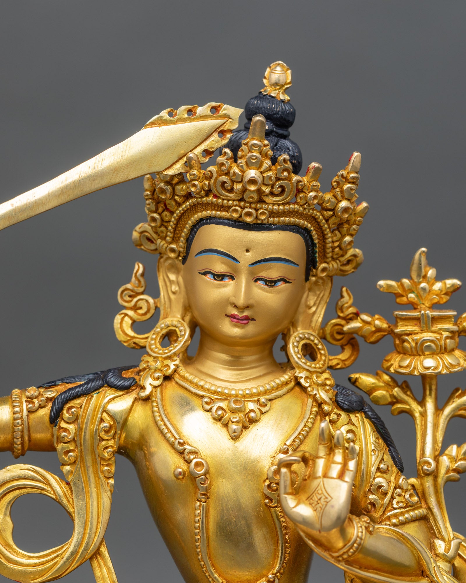 close-up-manjushri-face-gold-painted-lotus-handcrafted-nepal-buddhist-deity