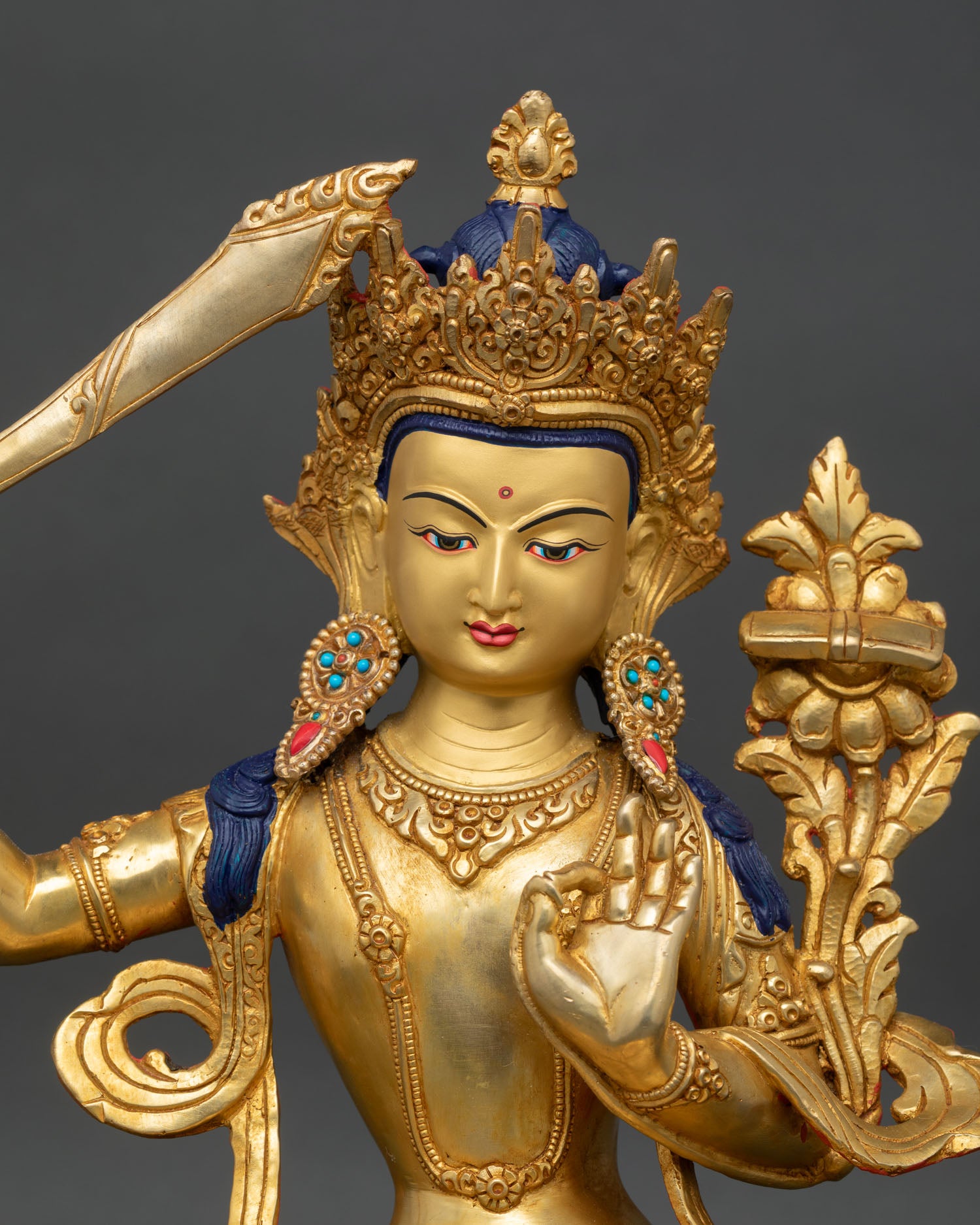Close up Manjushri holding flaming sword and Prajnaparamita Sutra wisdom deity, Himalayan Buddhist art detail