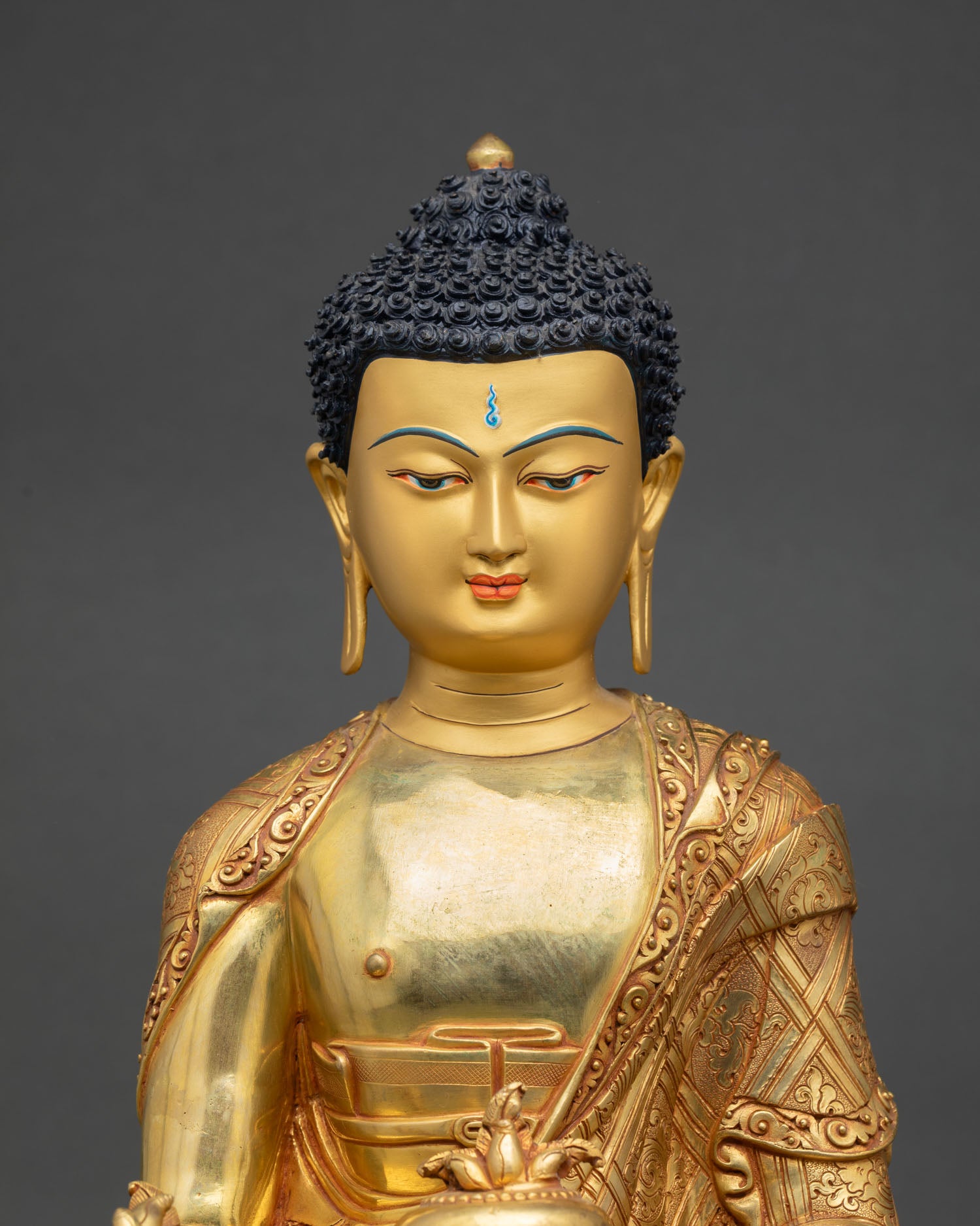 Close up Medicine Buddha face with hand painted gold finish showing serene expression healing energy and Buddhist compassion