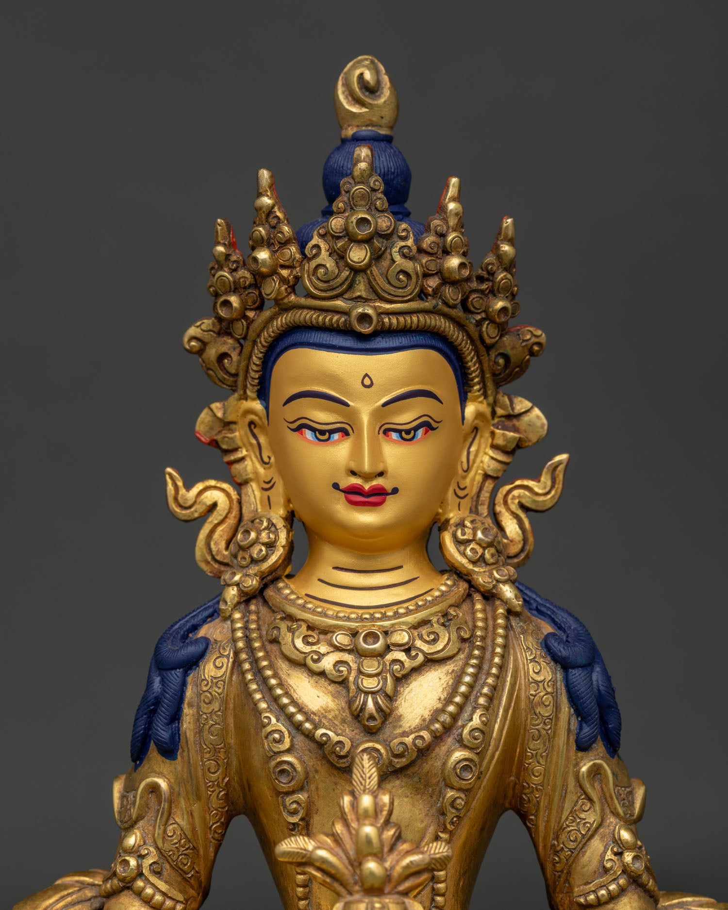 Close Up of Amitayus Gold Painted Face with Silk Robes and Dhyana Mudra Holding Tsebum.