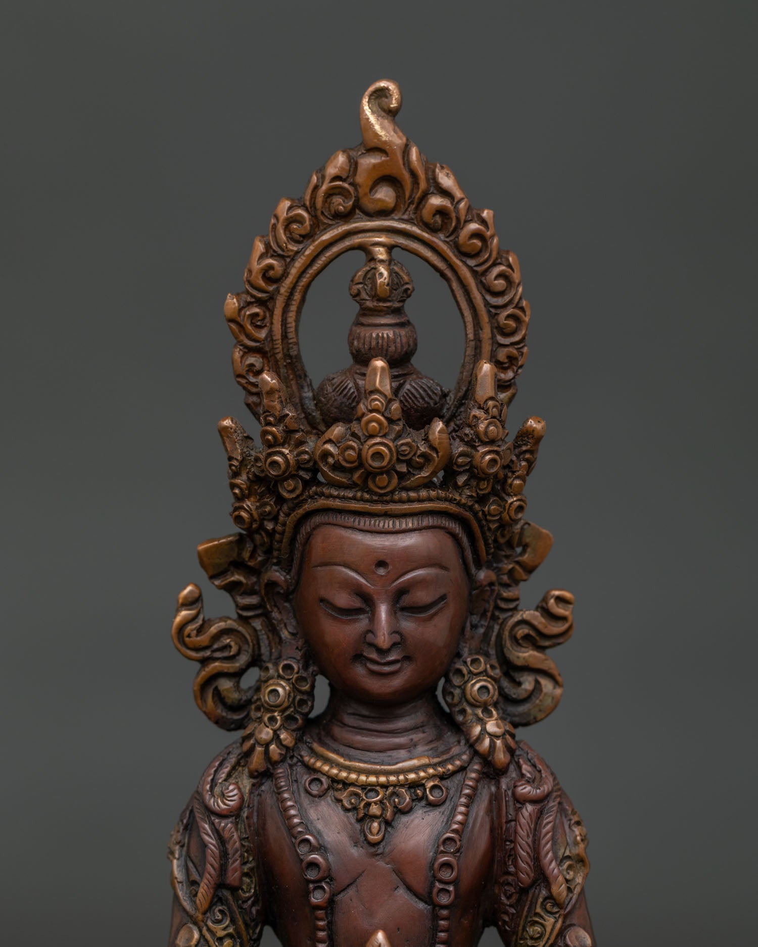 Close Up of Amitayus Statue with Five Jeweled Crown and Hand Carved Floral Robe Details.
