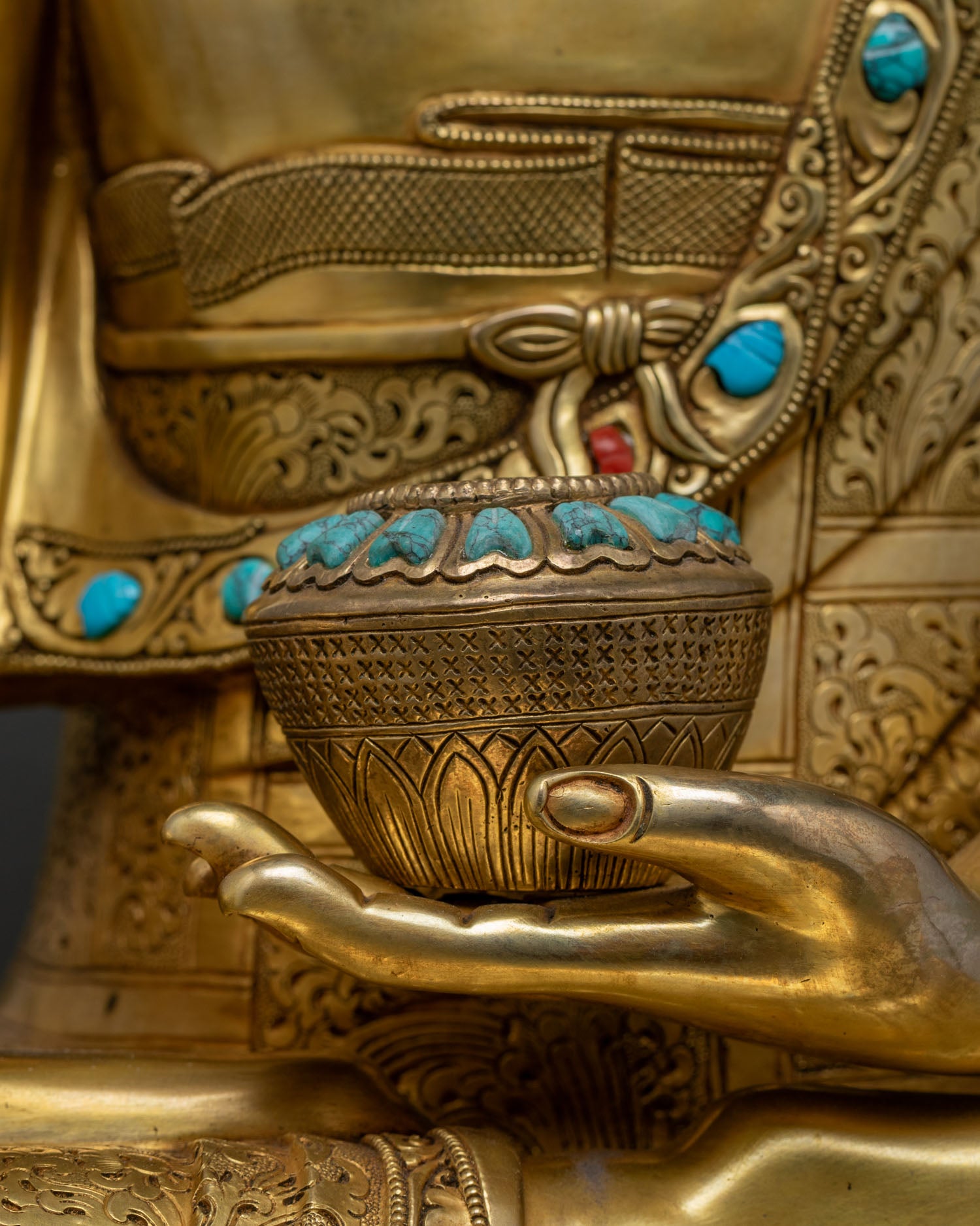Close-up of Buddha's hand holding begging bowl, symbol of renunciation