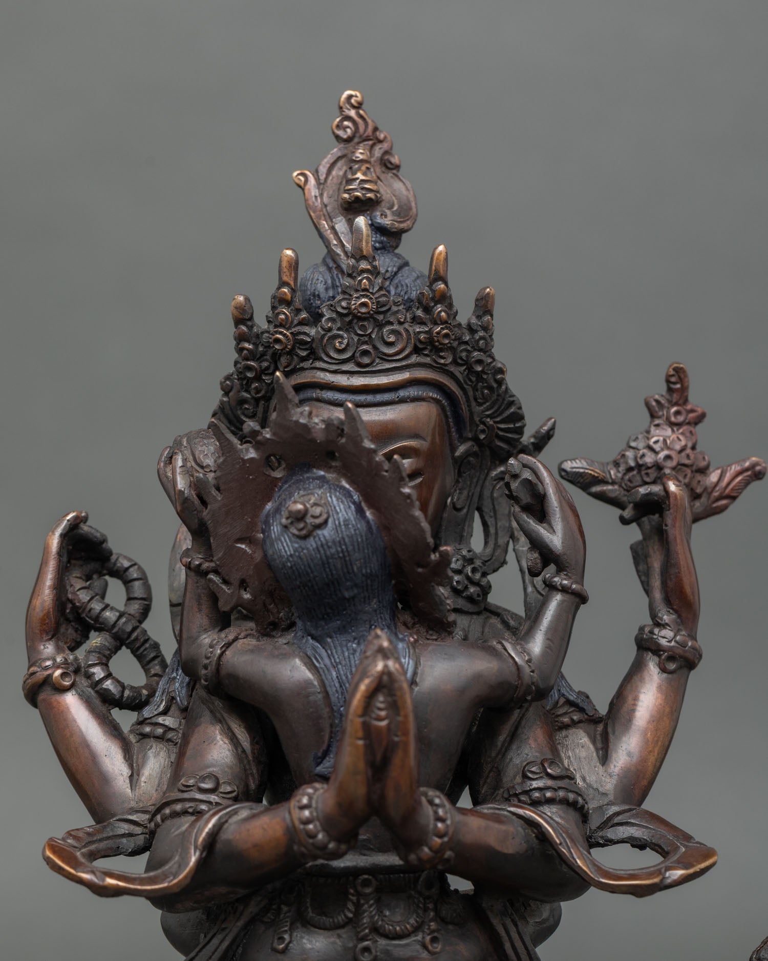 close up of chenrezig consort statue, vajra skull cup oxidized copper sculpture