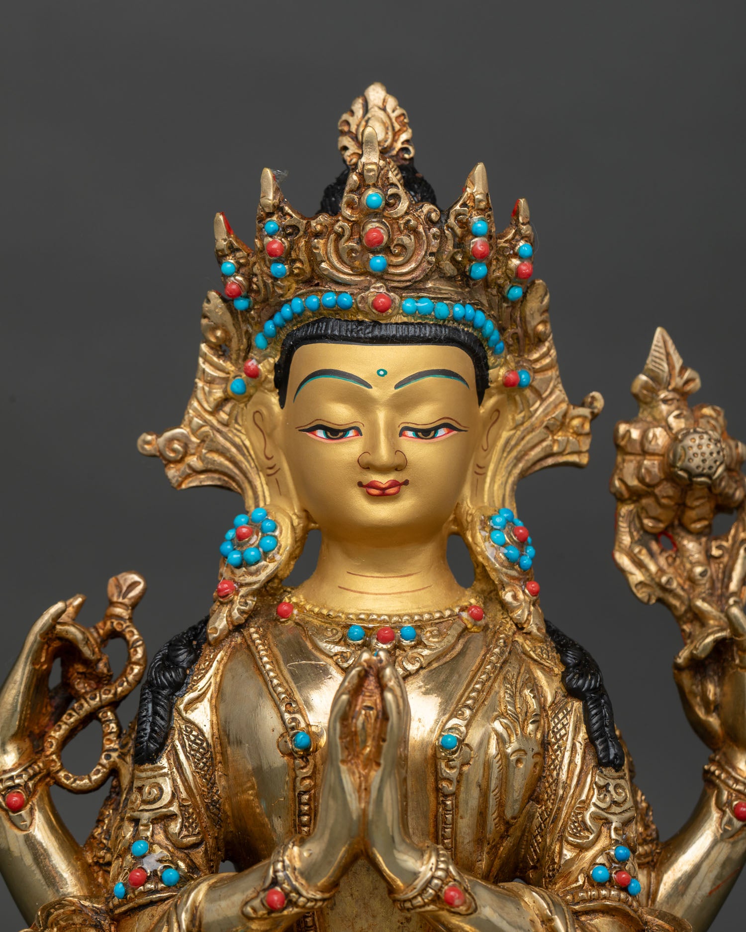 Close up of Chenrezig Statue showing intricate crown details and semi precious stone inlay