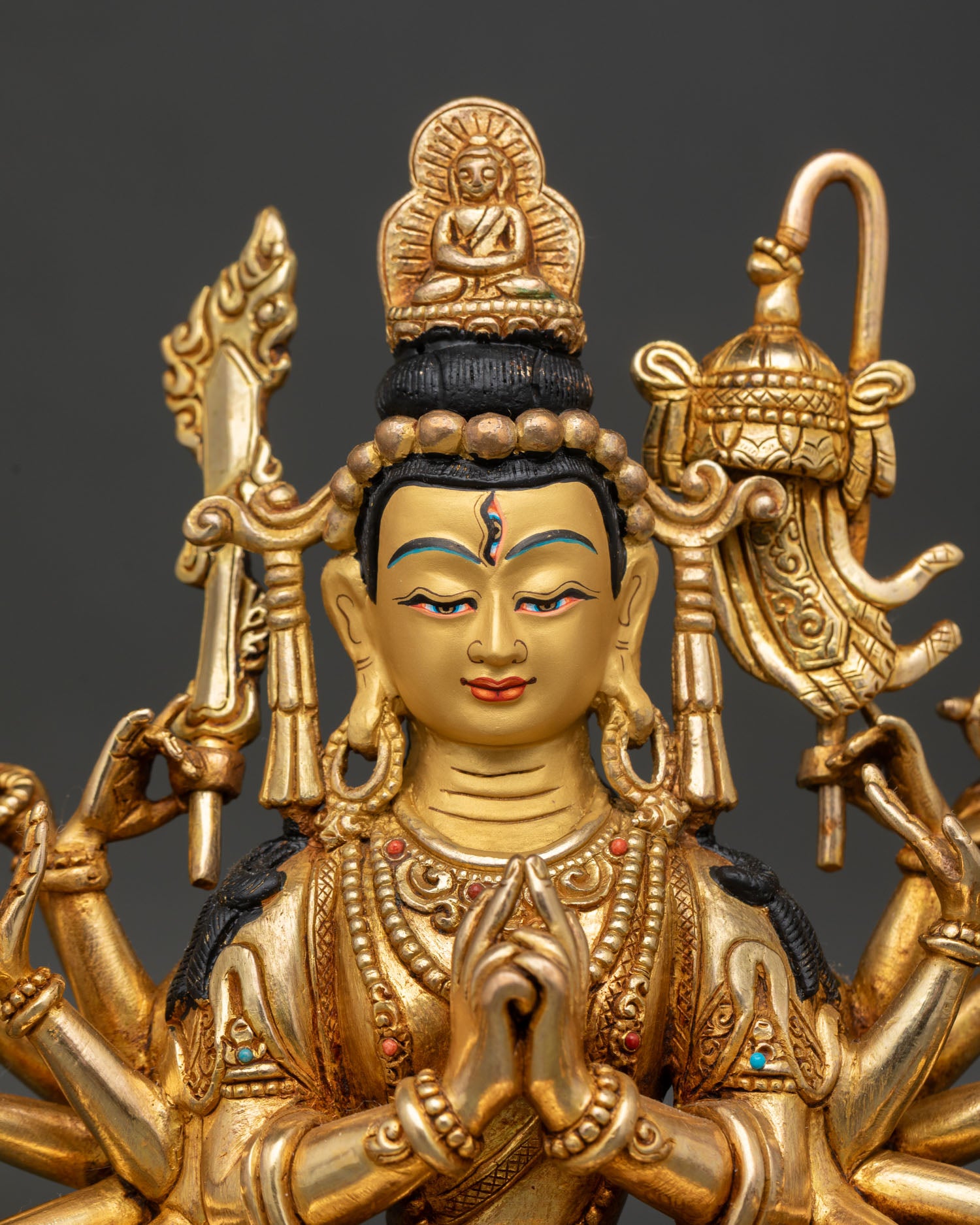 Close up of Chundi statue showing gold painted face jeweled crown and Amitabha Buddha detail