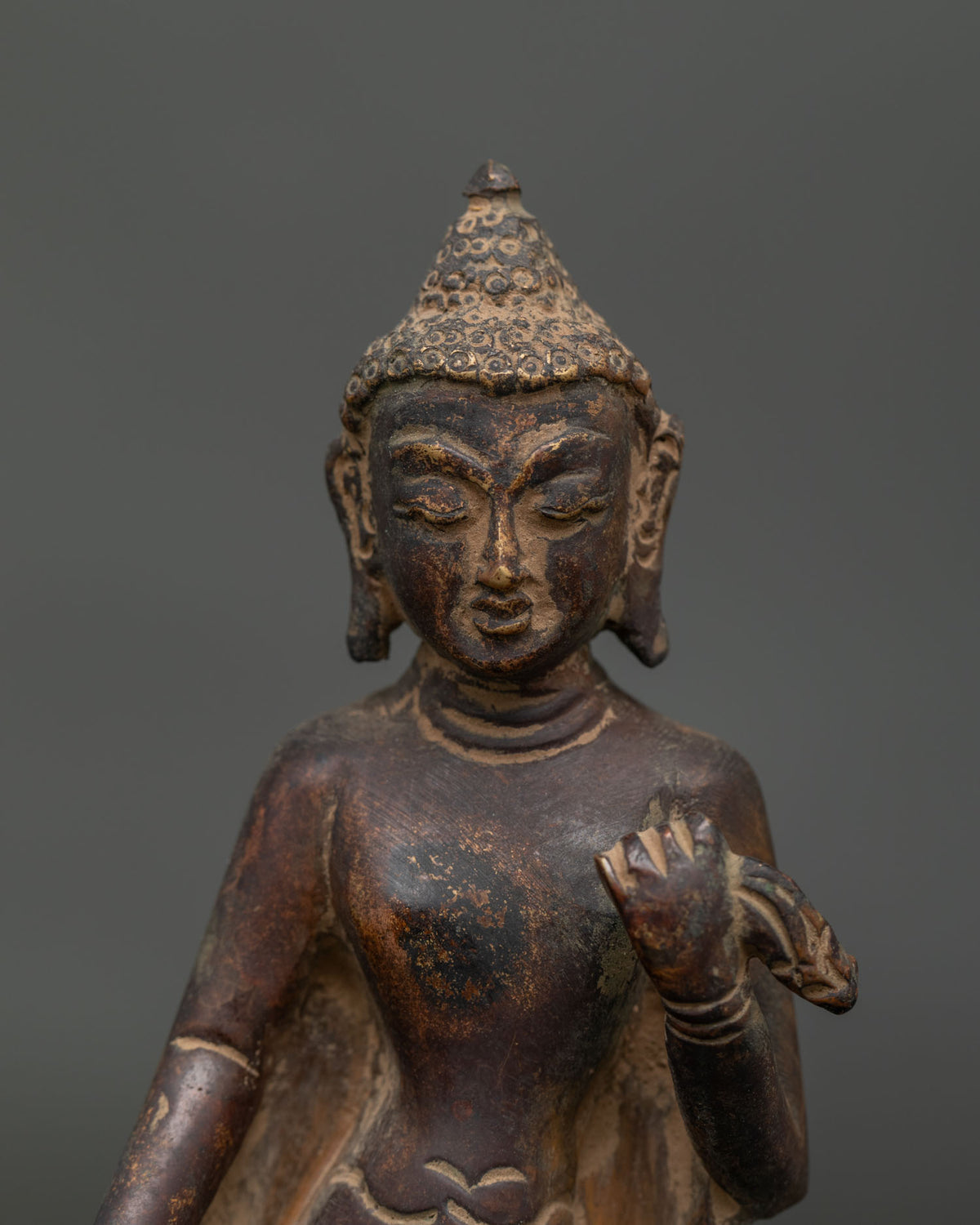 Close up of Dipankara Buddha face showing tranquil expression and detailed Newari craftsmanship.