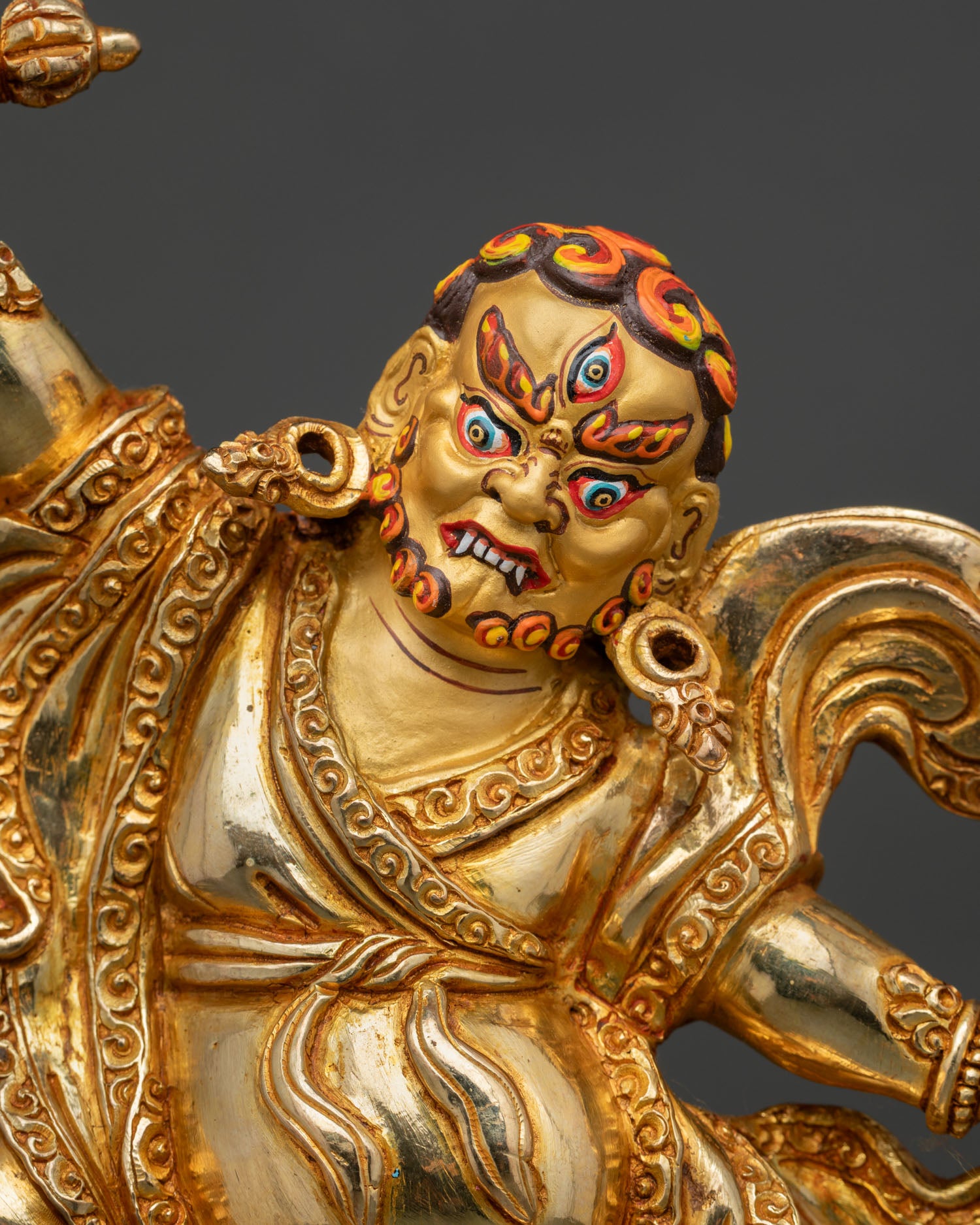 Close-up of Dorje Drolo Statue highlighting the fierce gold-painted face, wrathful expression, Vajra weapon, and detailed Newari artistry.