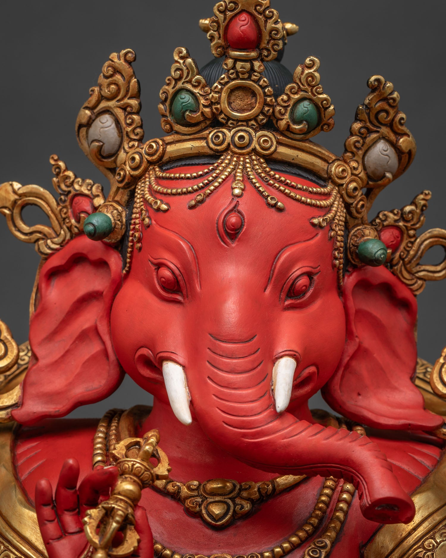 Side Close-Up of Ganesh Idol's Arms Holding Ritual Implements