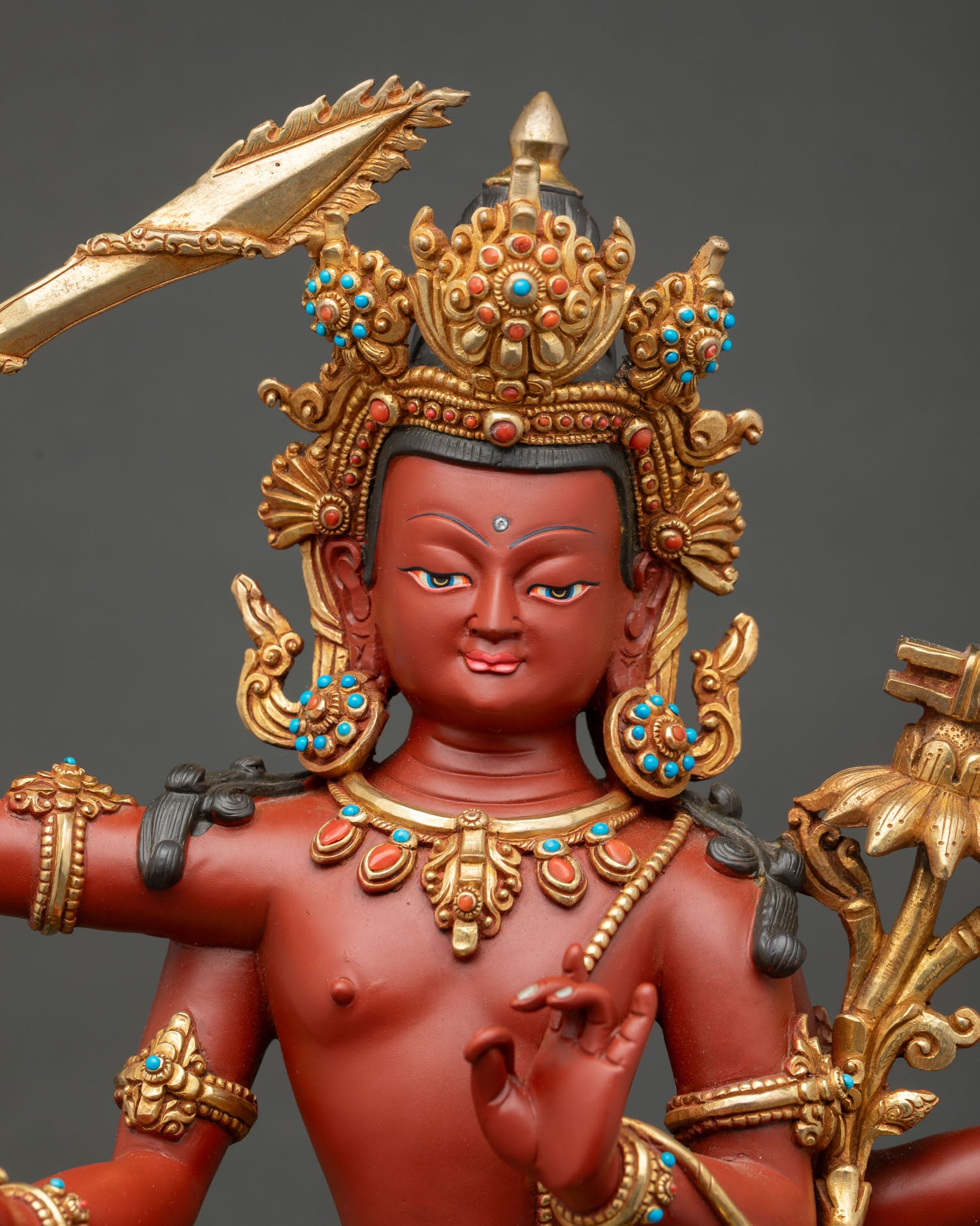 Close-up of Four-Armed Maha Manjushri face, gold gilded crown detail
