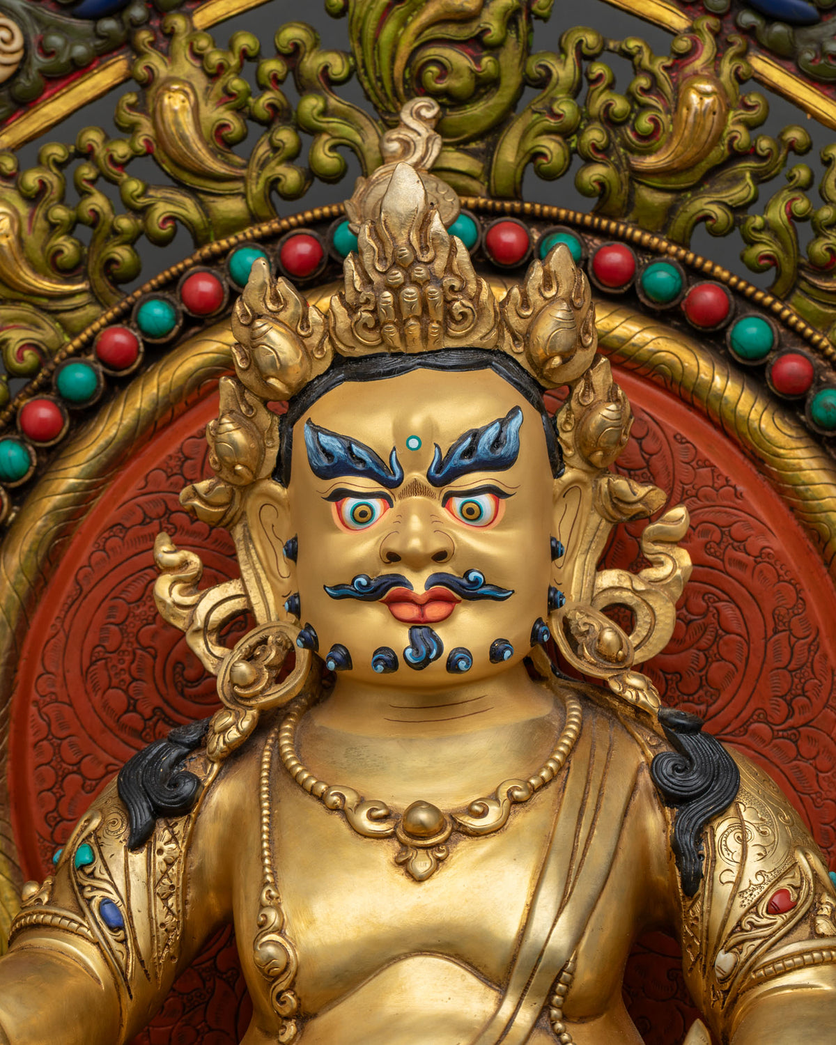 Close-up of gold gilded Dzambhala statue, Nepali Buddhist god of wealth and abundance