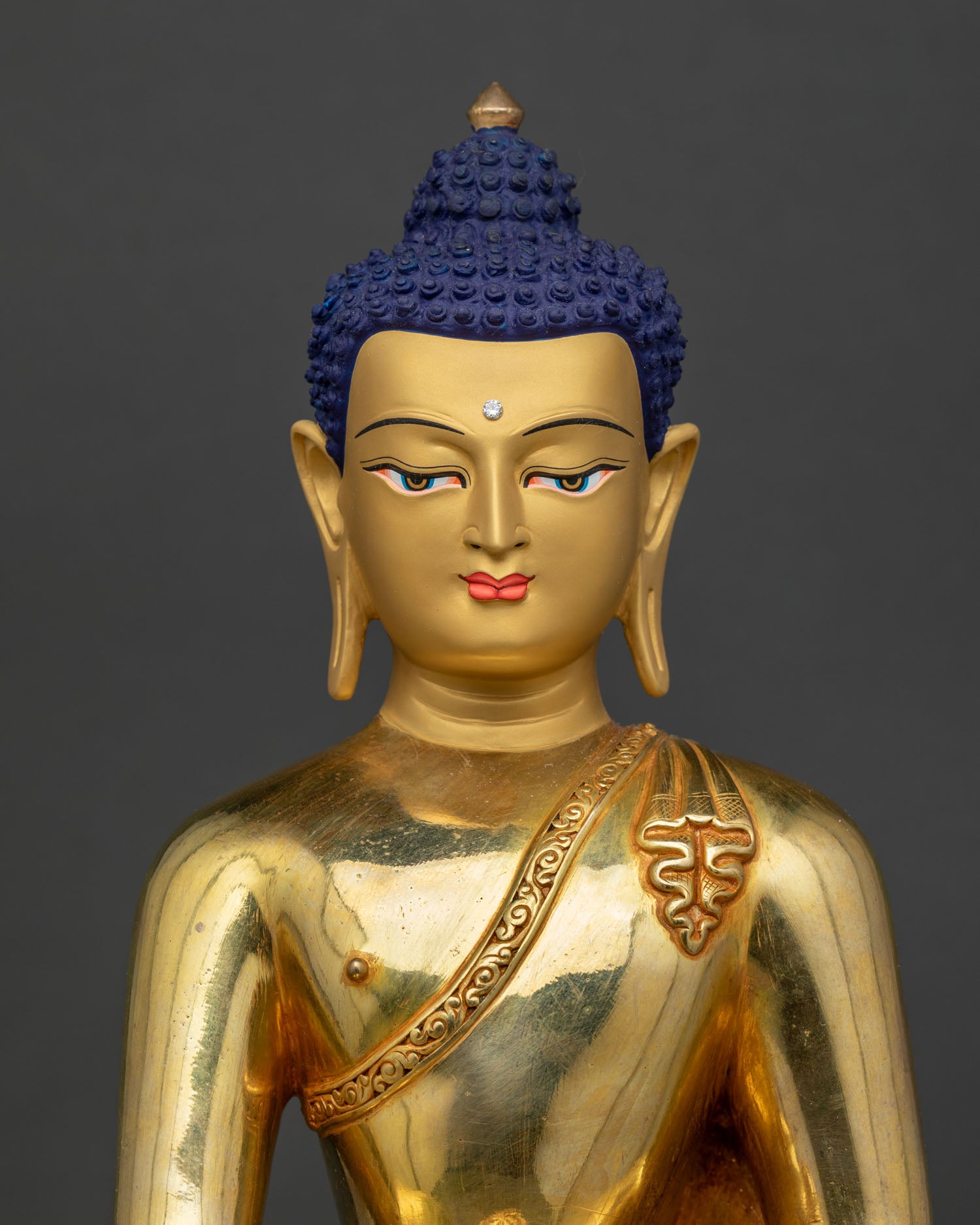 Close-up of gold Shakyamuni Buddha statue, fire-gilded copper, lotus seat, intricate robe detailing Nepal