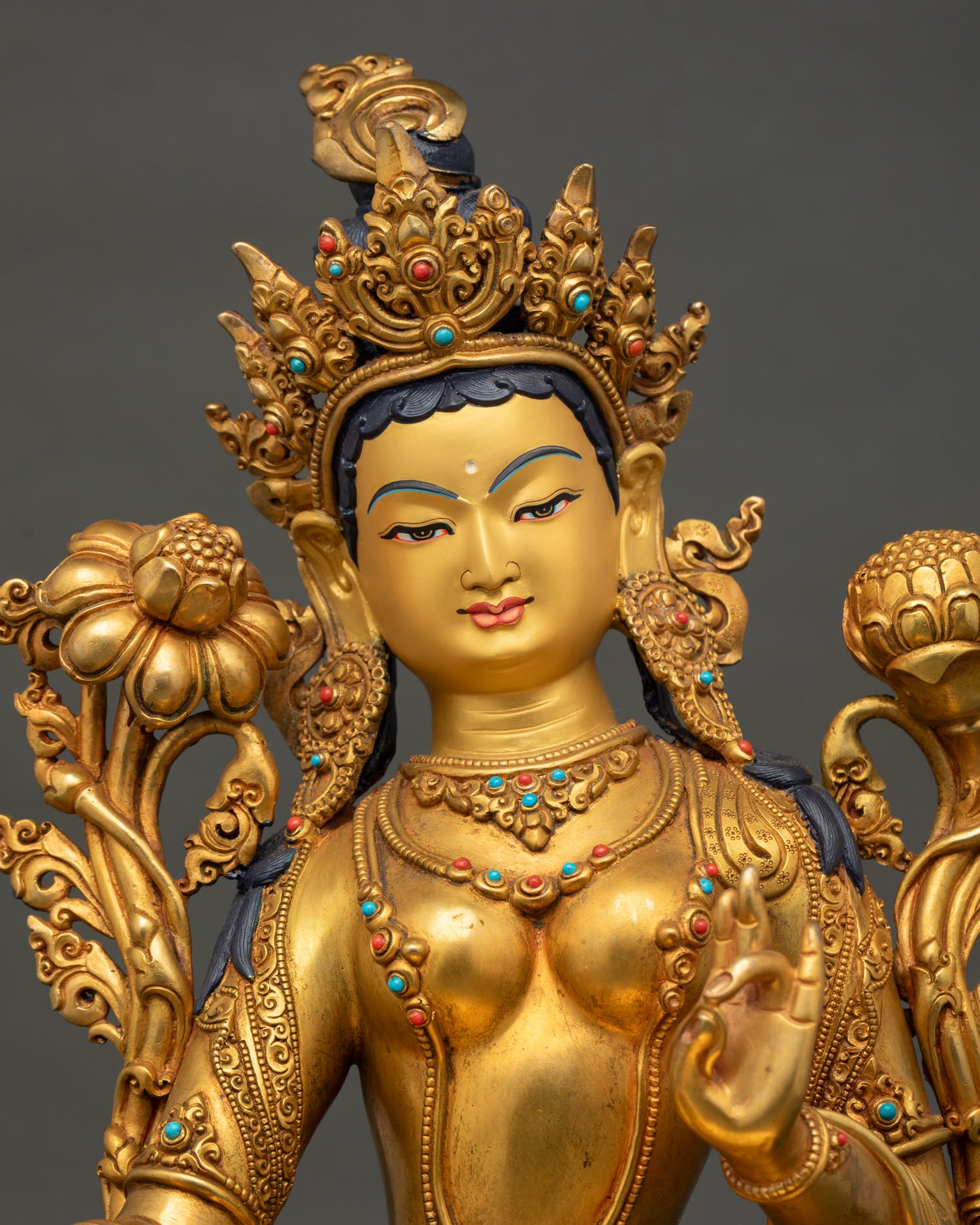 Close-up of Green Tara Statue with fire-gilded gold and gemstone details