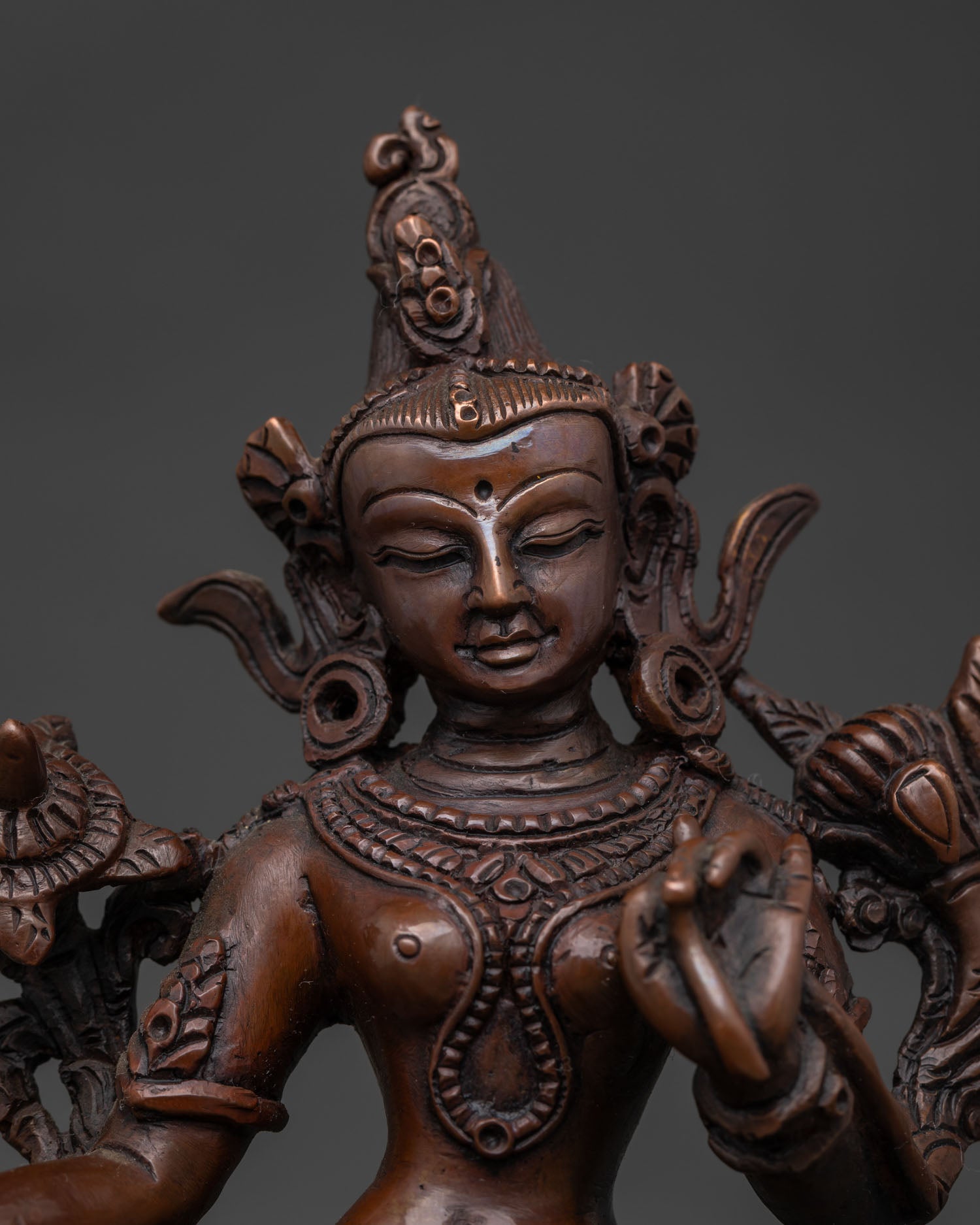 Close Up of Green Tara Statue with Hand Carved Silk Garments and Jewelry.