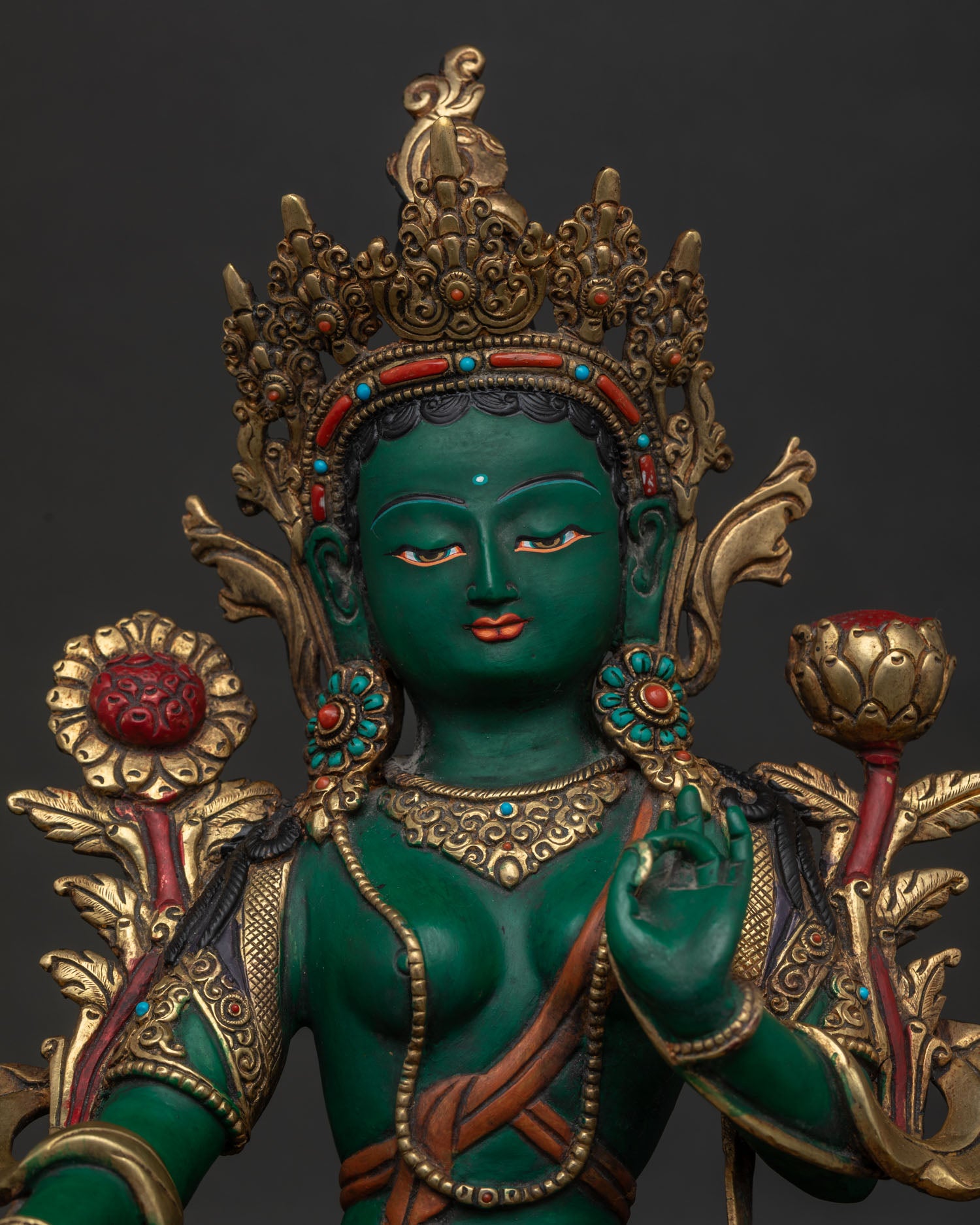 Close Up of Green Tara Statue with Semi Precious Stones and Gold Gilded Face Details.