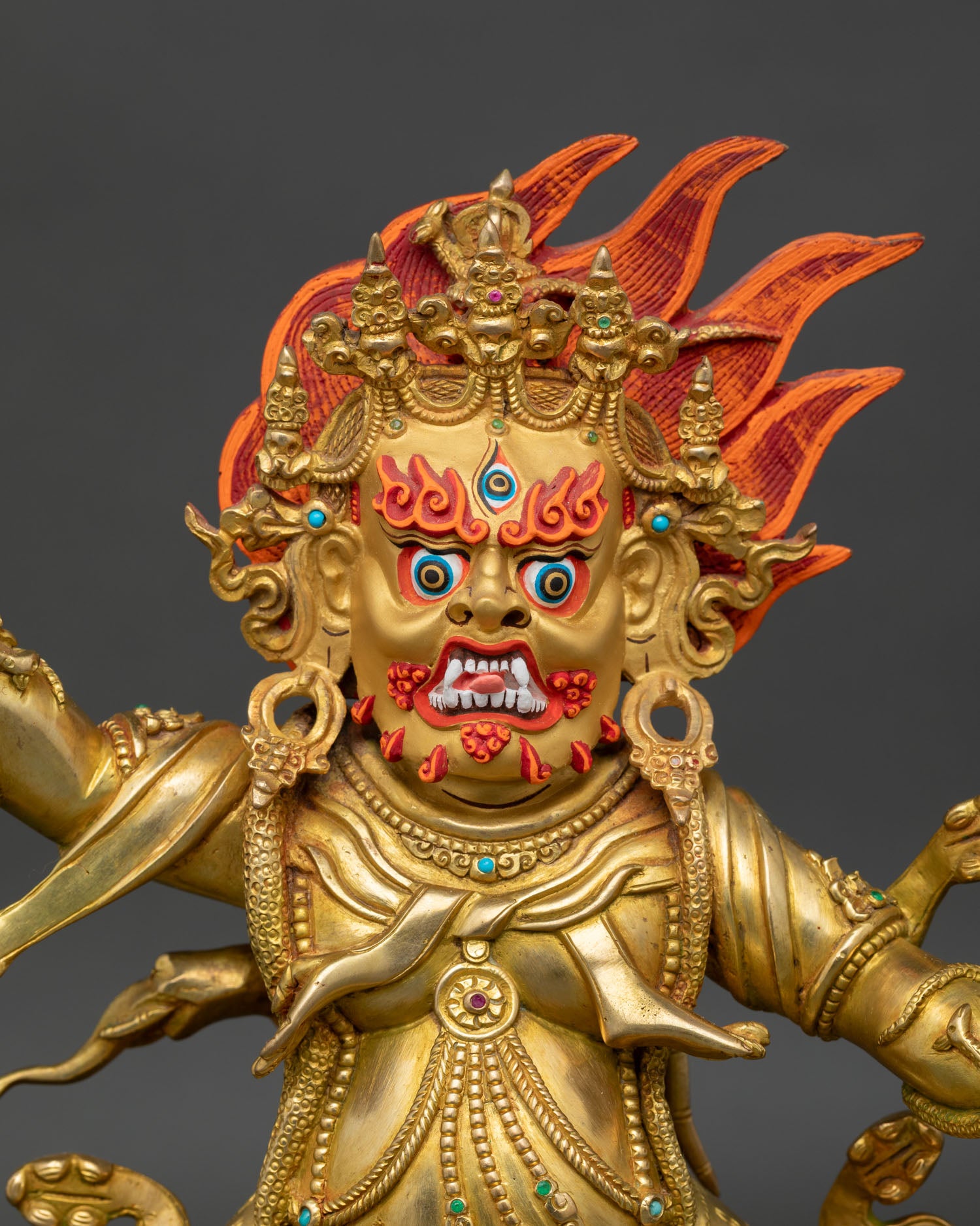Close up of Guru Dragpo Buddhist statue with intricate gold gilded craftsmanship