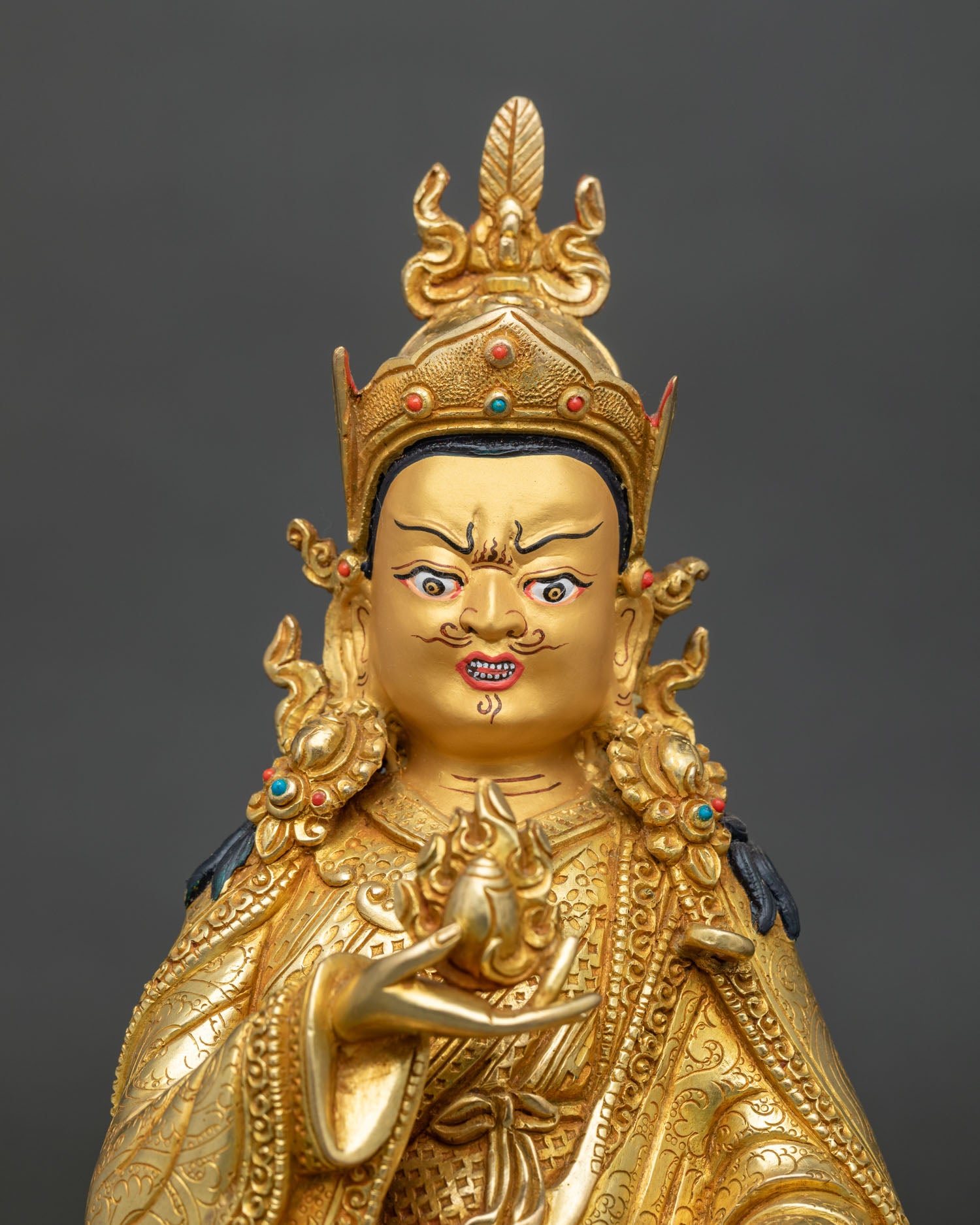 Close Up of Guru Norla Statue with Gold Painted Face, Lotus Hat and Vulture Feather