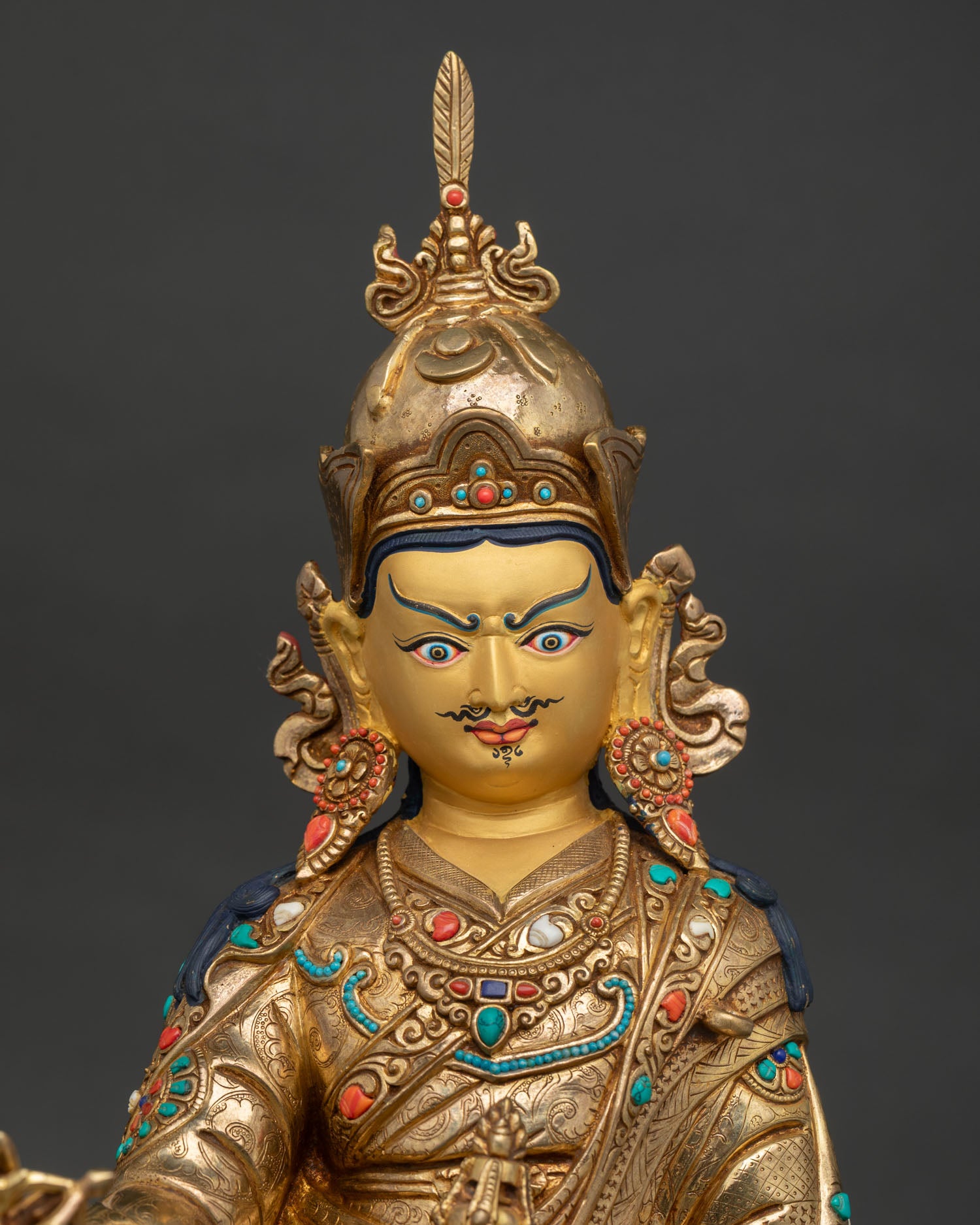 Close-up of Guru Rinpoche Statue showing semi-wrathful expression and intricate details