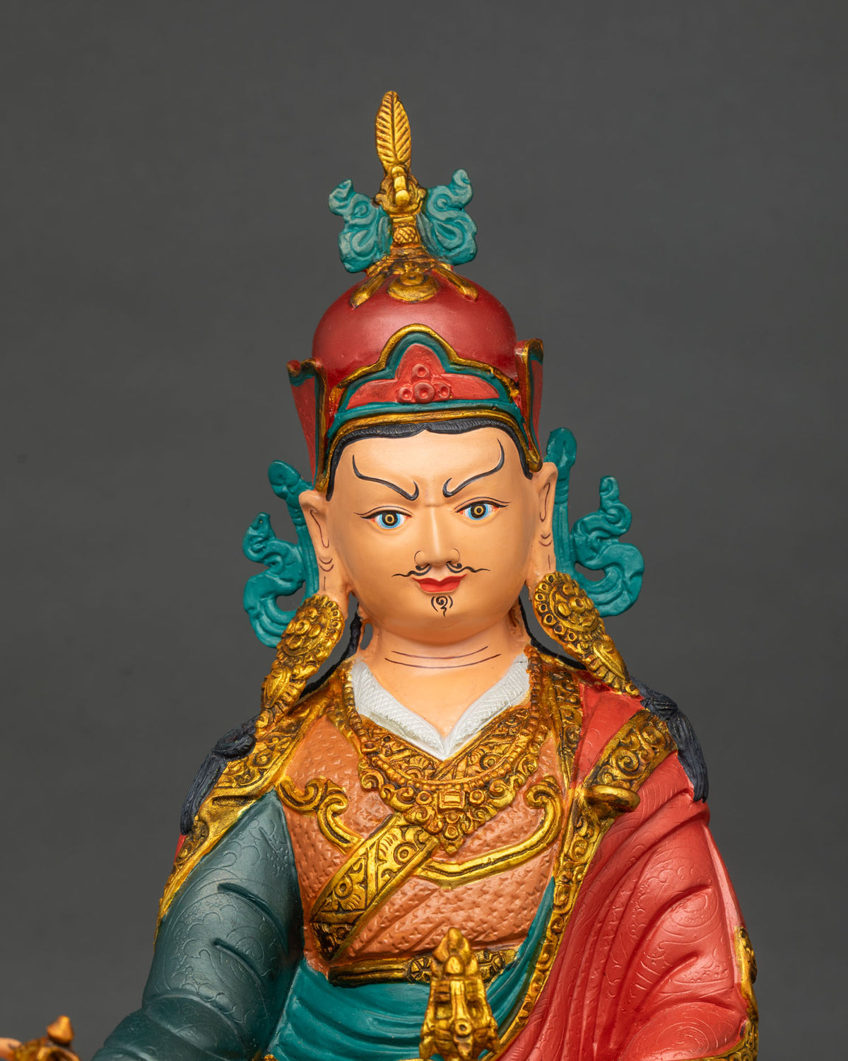 Close up of Guru Rinpoche statue with vajra and skull cup, copper Padmasambhava from Nepal