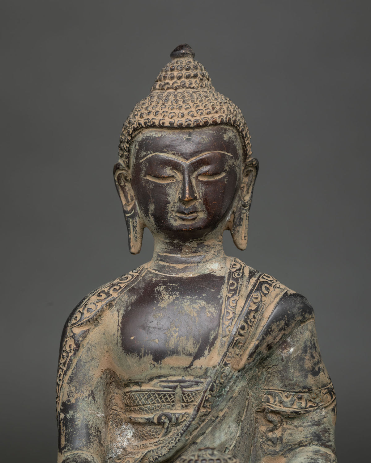 Close-up of handcrafted copper Shakyamuni Buddha statue with detailed antique finish