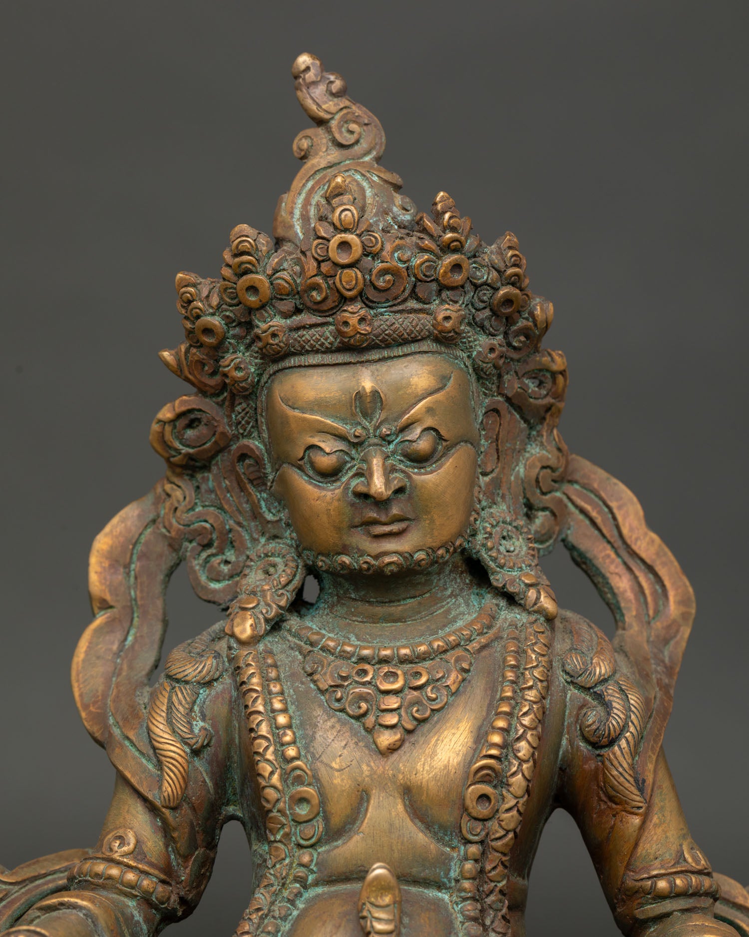 close-up of handcrafted dzambhala statue with antique oxidized copper finish from nepal
