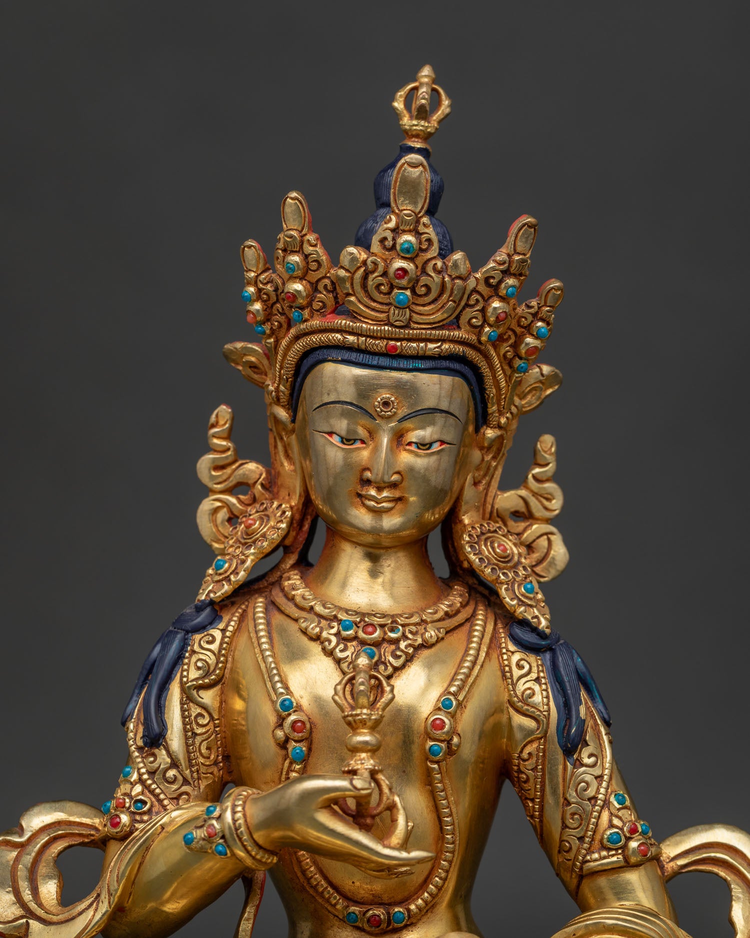 Close up of handmade Dorje Sempa copper alloy sculpture showing royal attire and semi-precious stones.
